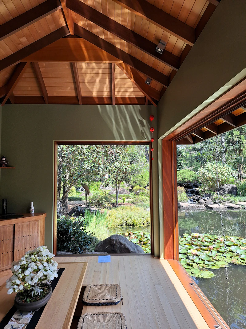 Traditional Japanese tea room with tatami mats and a window to a moss garden