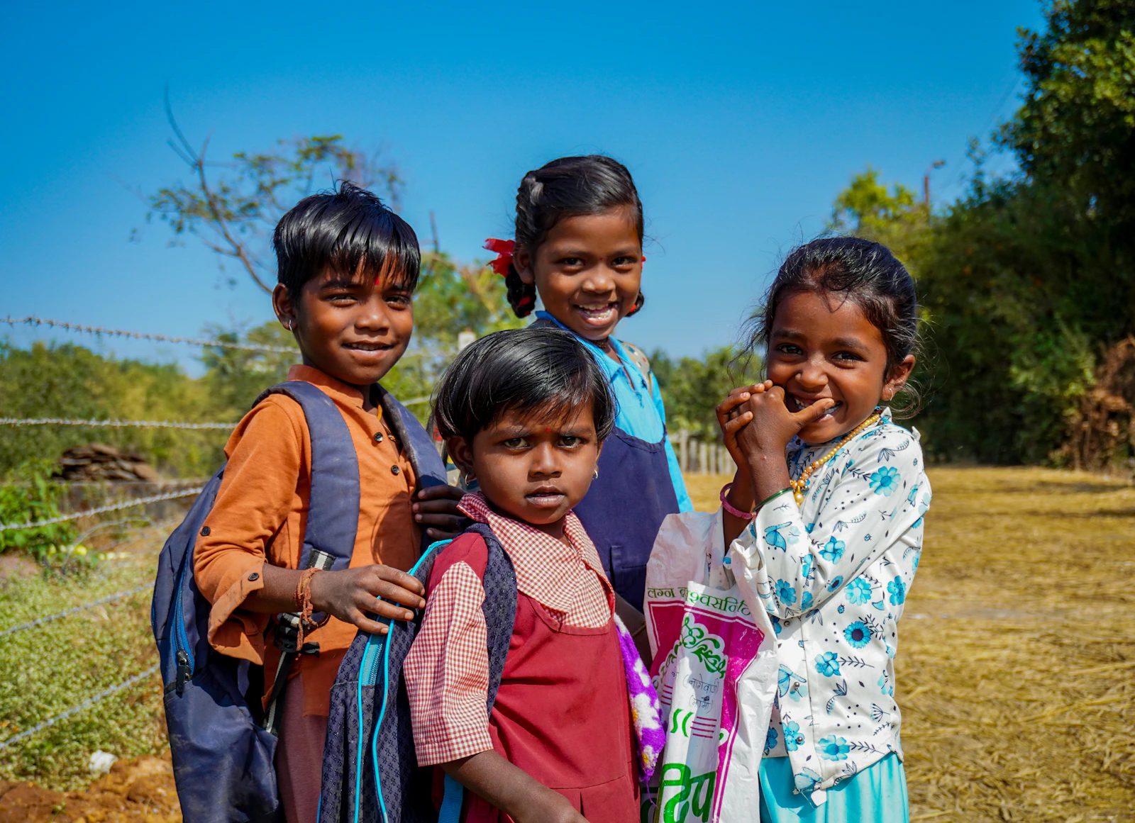 A group of young children standing together outdoors
