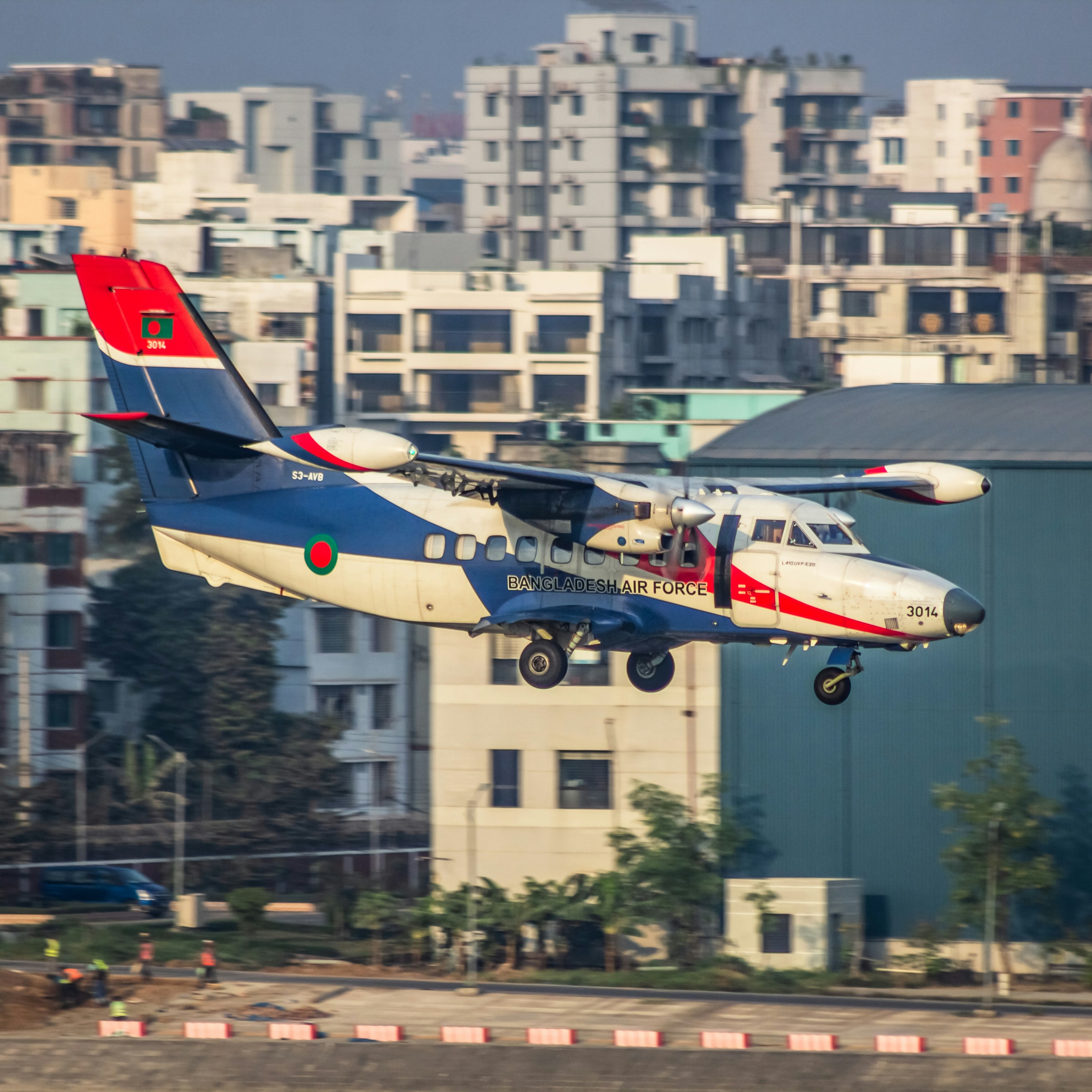 A plane is flying low over a city