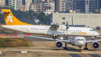 A white and yellow airplane is on a runway