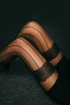 A woman in stockings and stockings laying on the floor