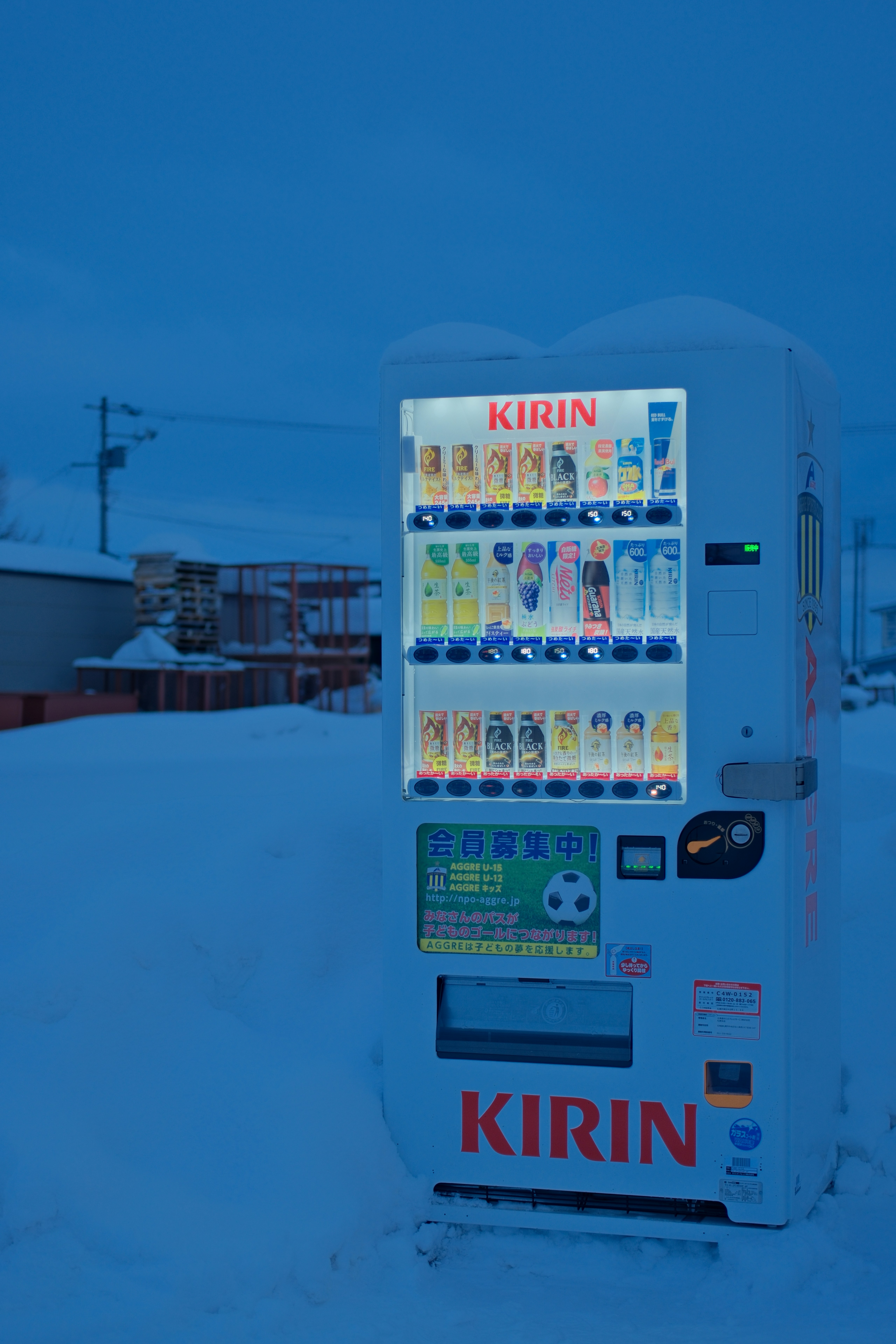 A vending machine sitting in the middle of a snow covered field