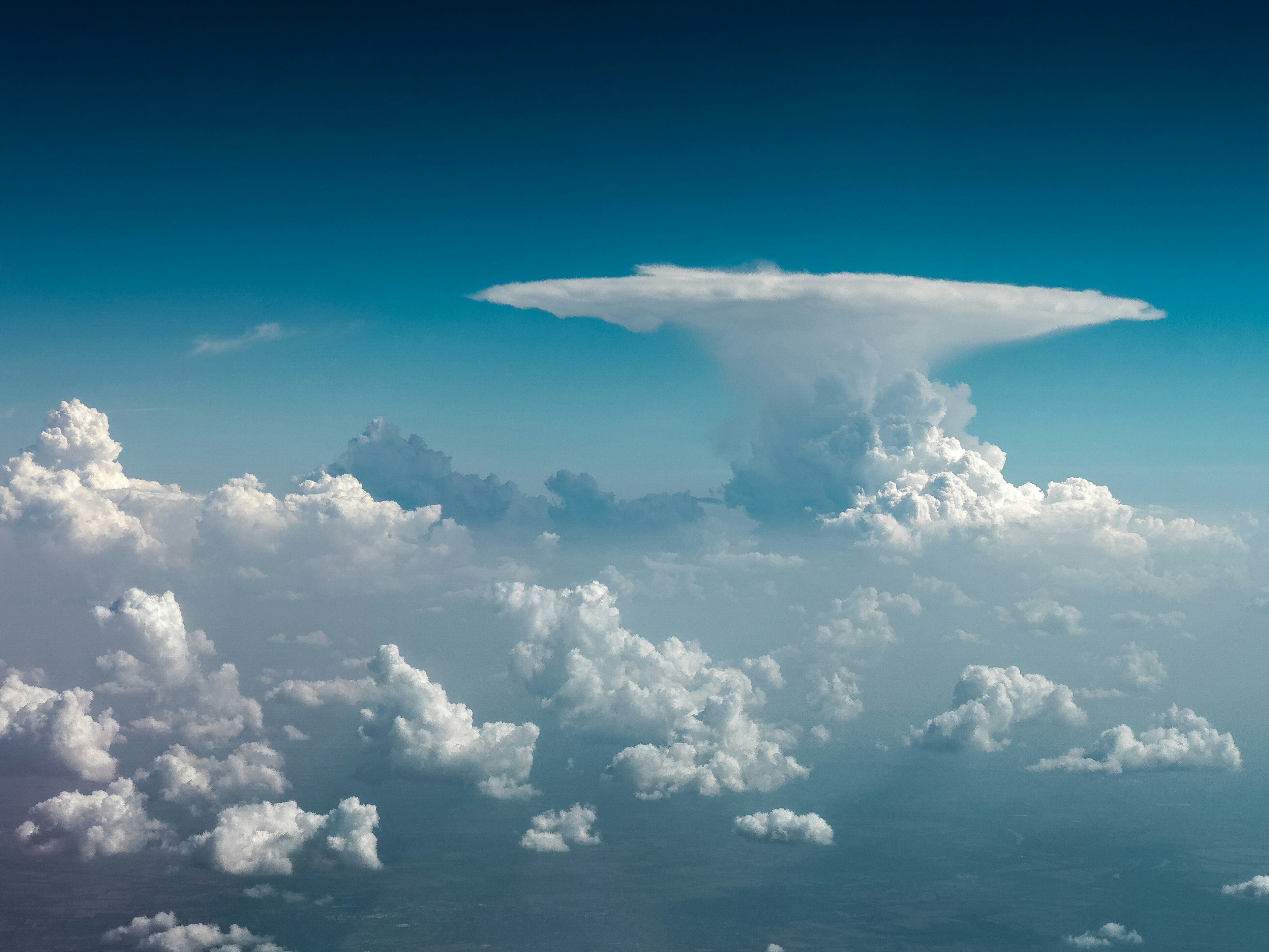 A large cloud in the middle of a blue sky