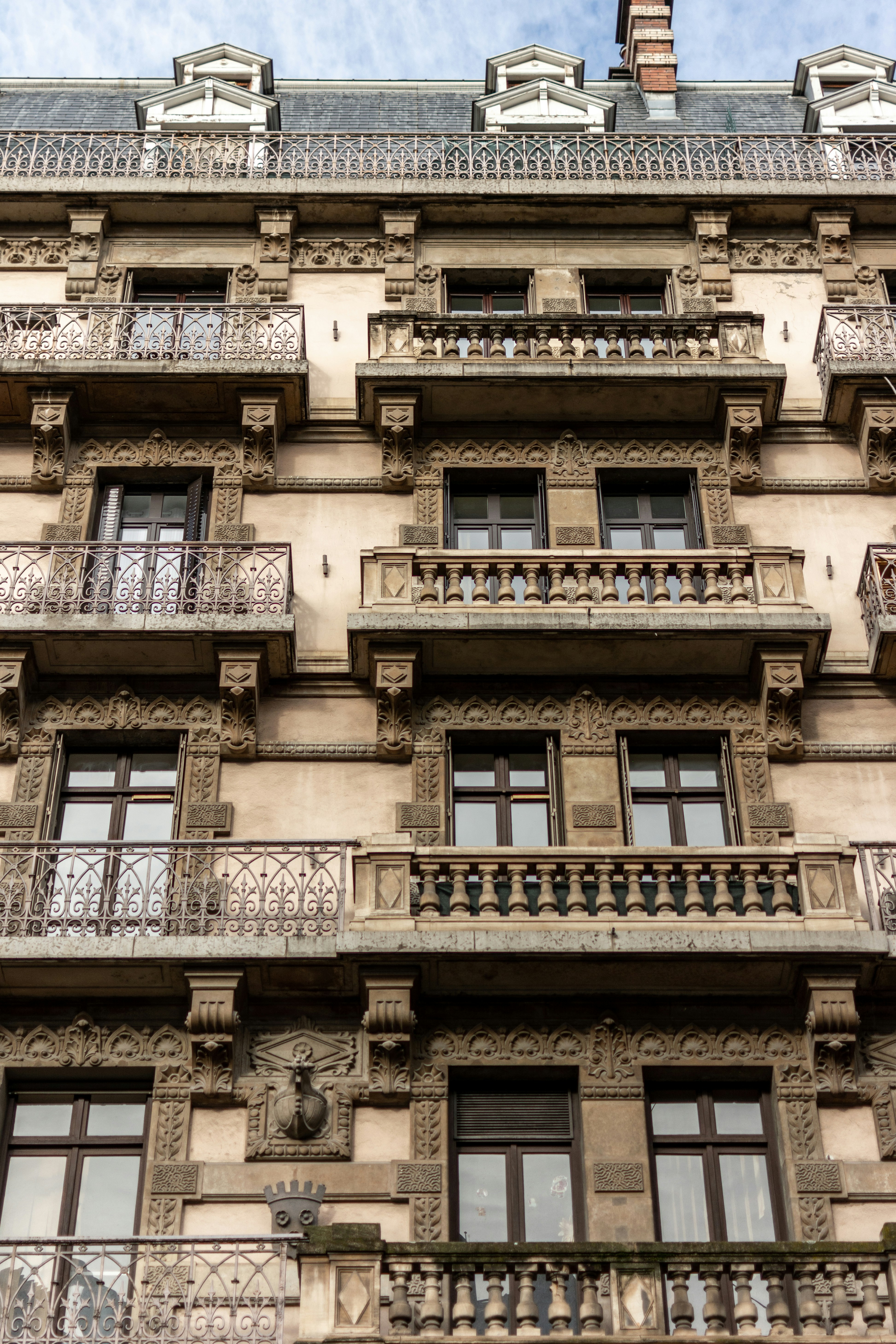 A tall building with many balconies and windows