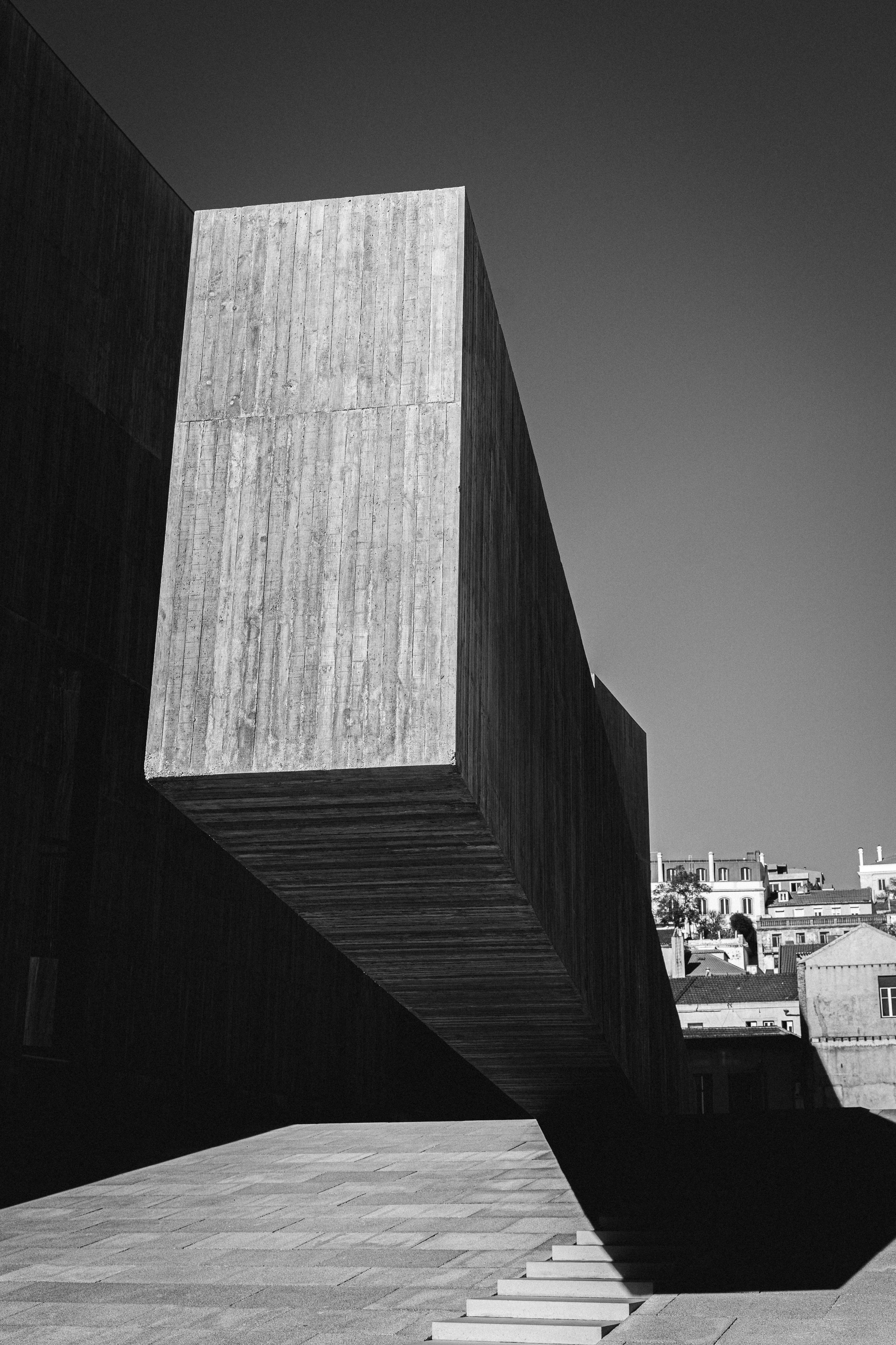 A black and white photo of stairs leading to a building