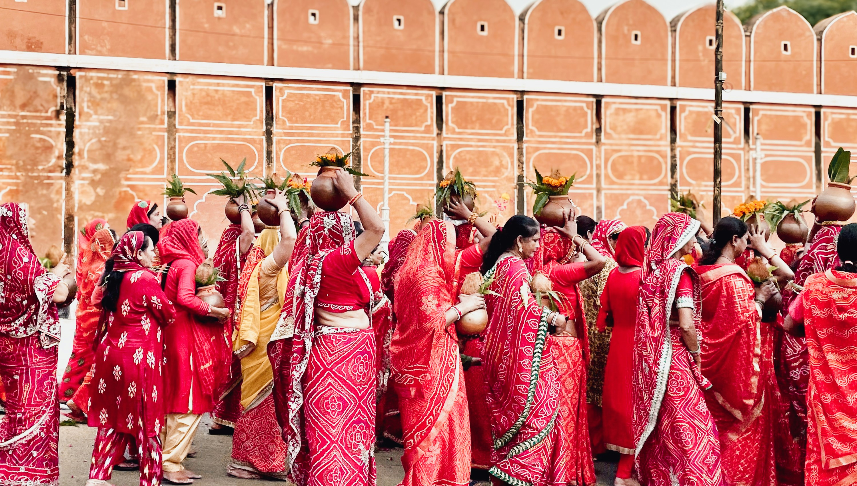 A group of women in red dresses standing next to each other