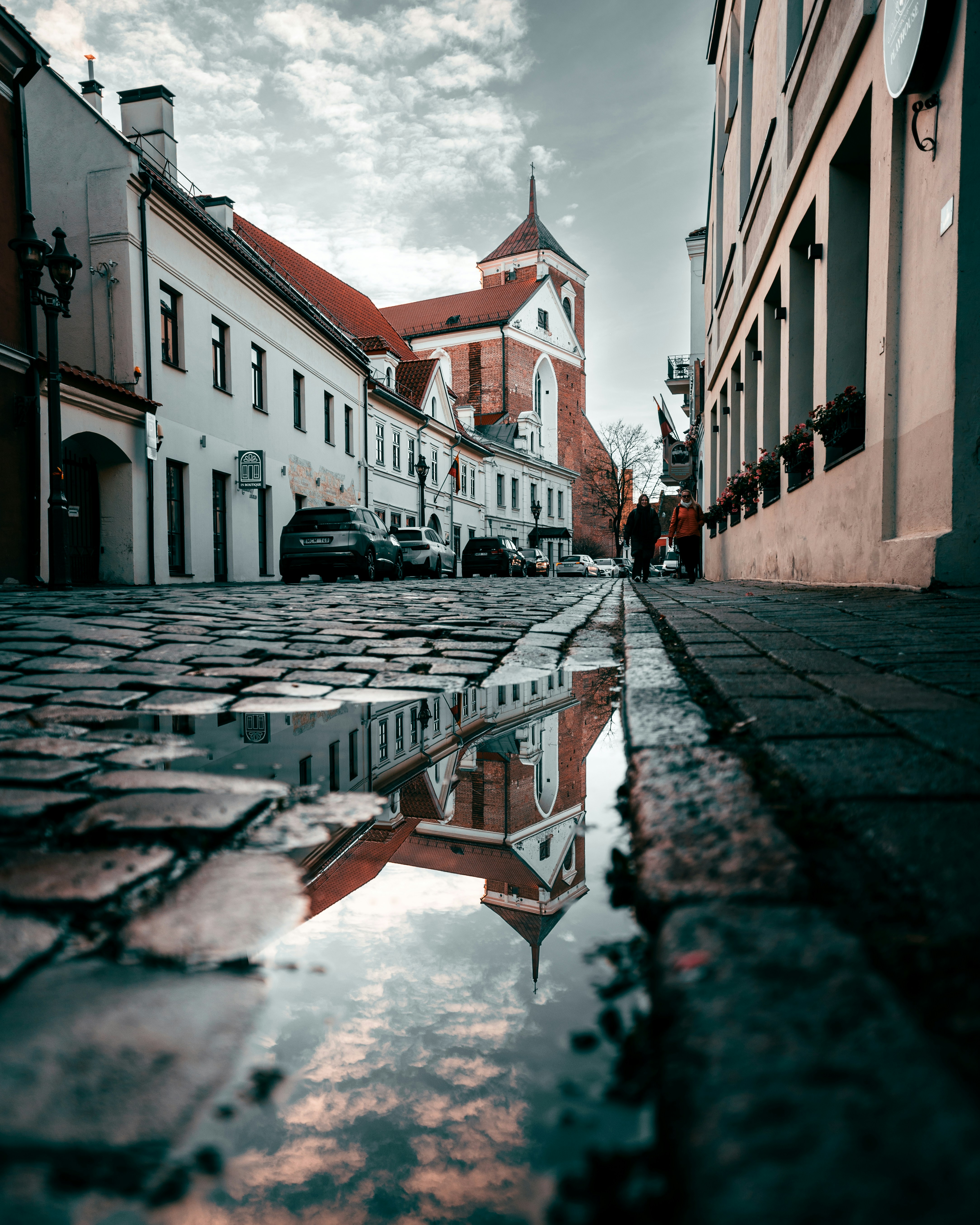 A reflection of a church in a puddle of water