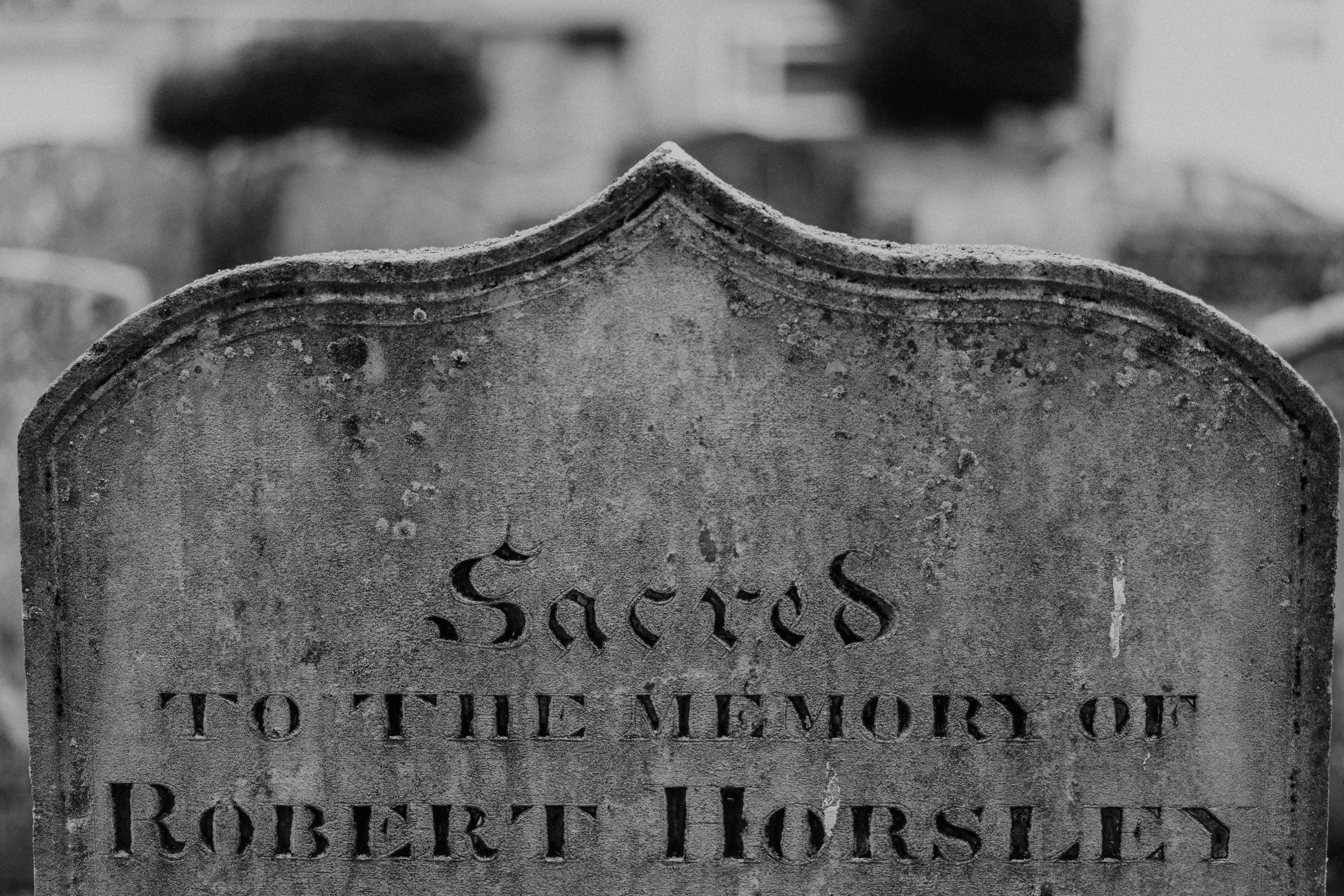A headstone with a name on it in a cemetery