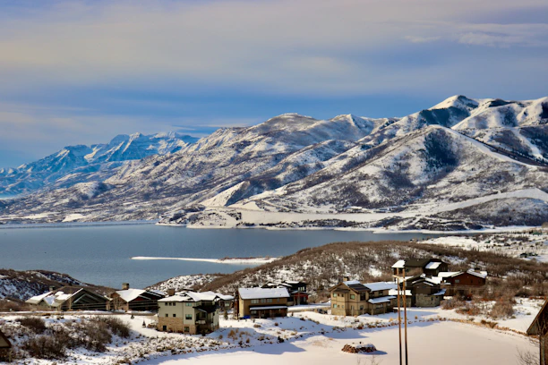 A view of a mountain range with a lake in the foreground
