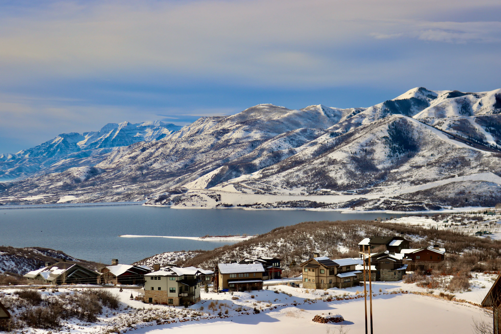 A view of a mountain range with a lake in the foreground