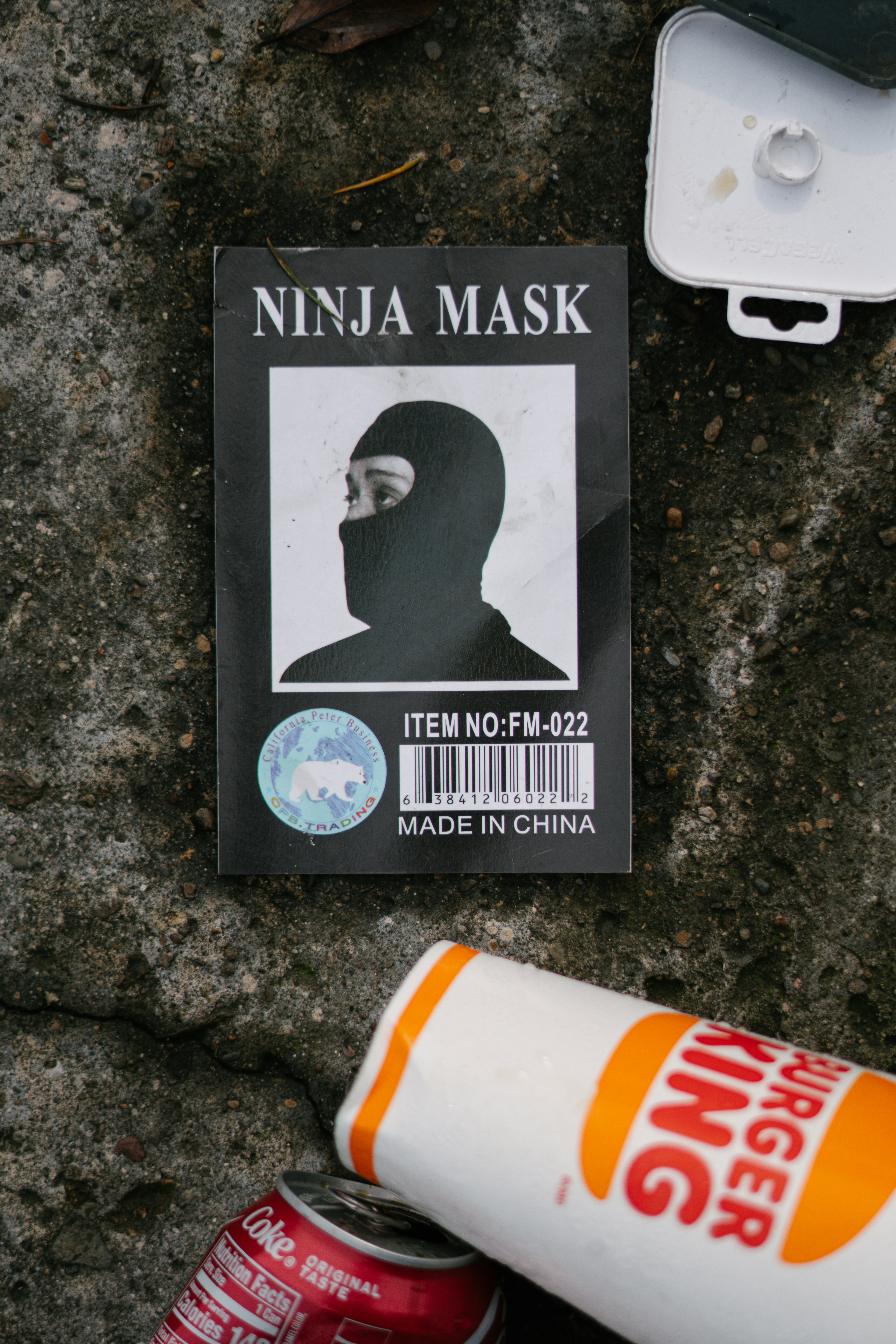 A picture of a man's face on a sticker next to a can