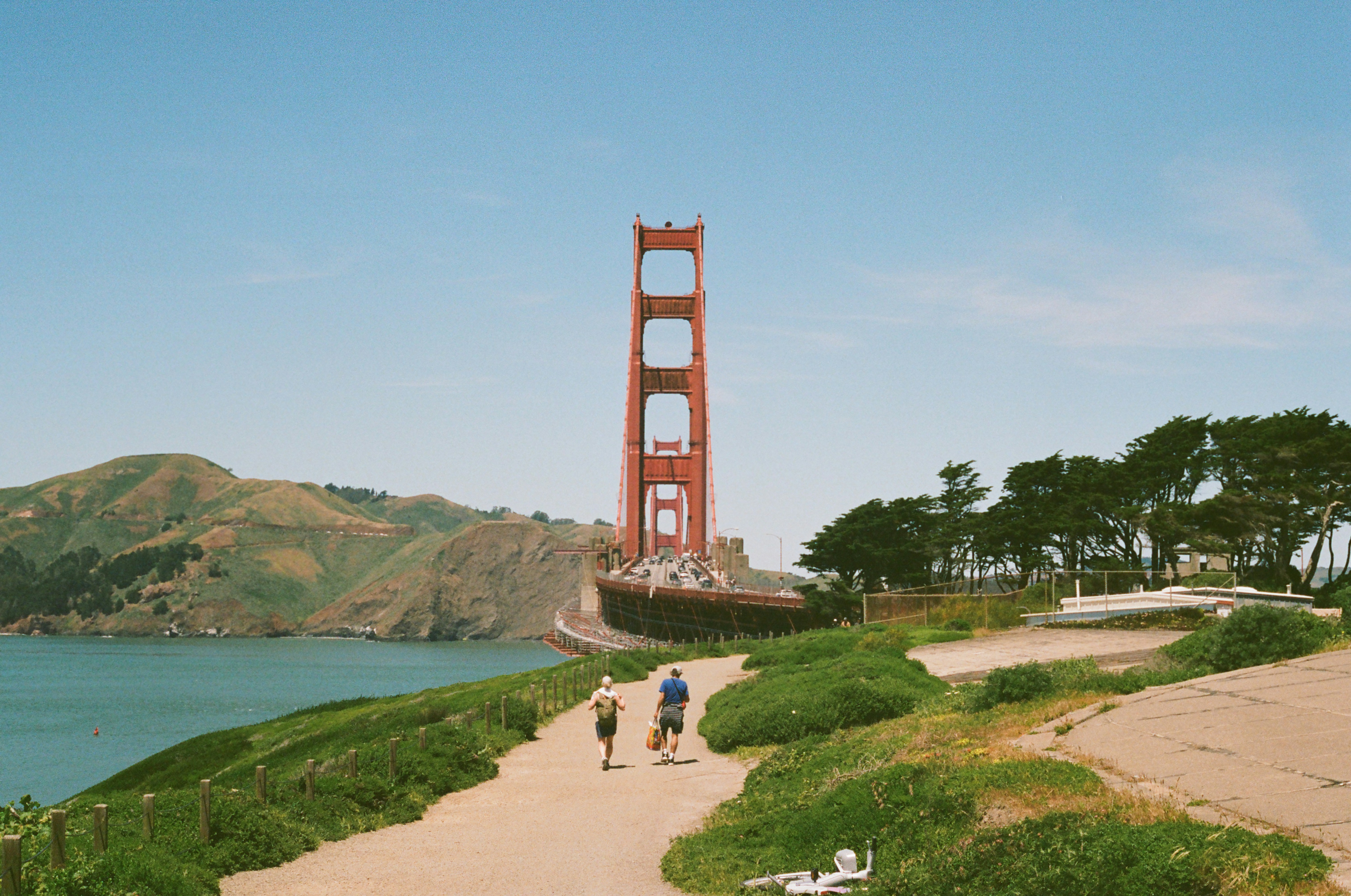 A couple of people that are walking down a path