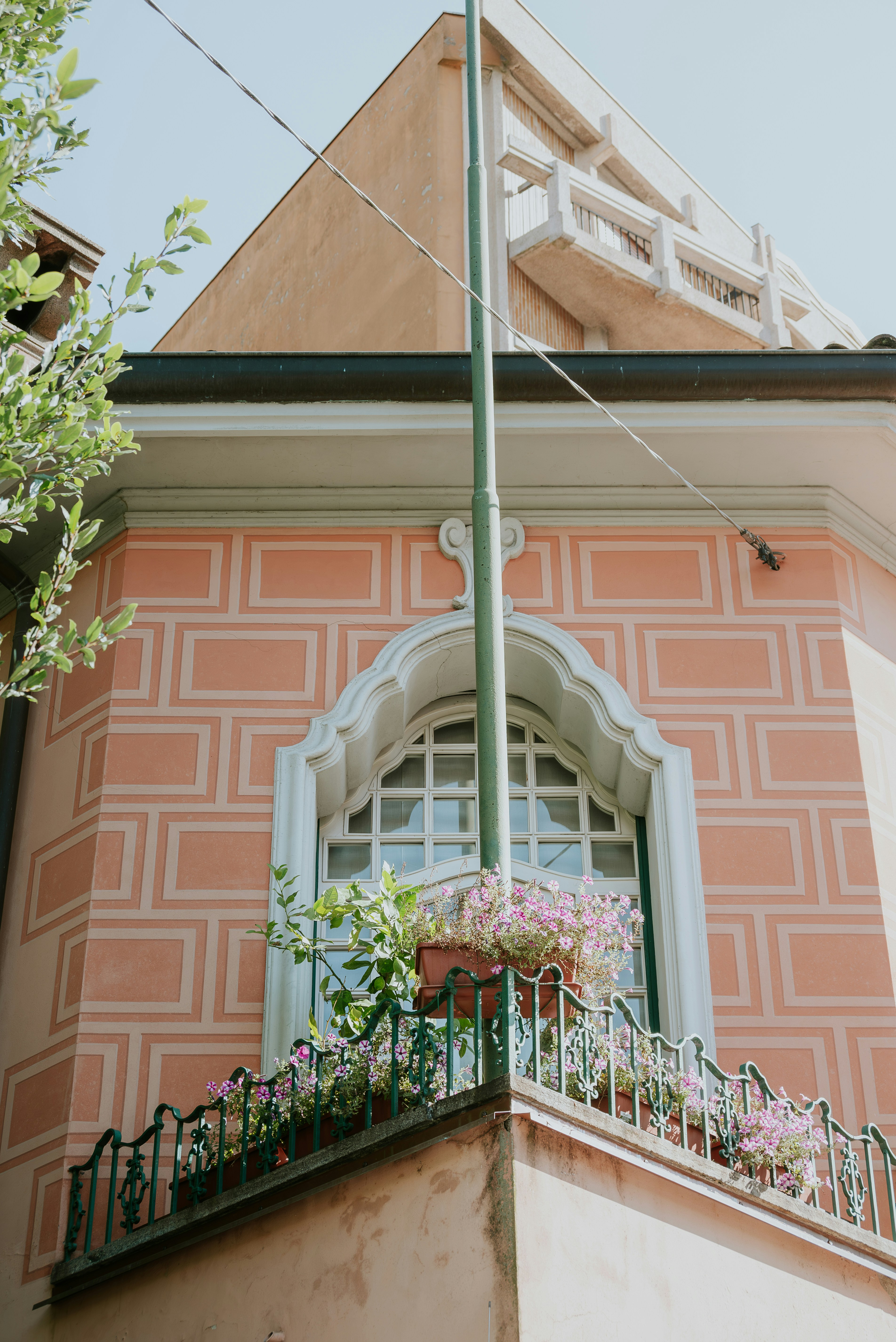 A building with a balcony and a flag pole