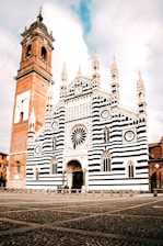 A large white and black building with a clock tower