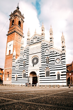 A large white and black building with a clock tower