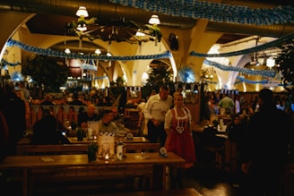 A group of people sitting at tables in a restaurant