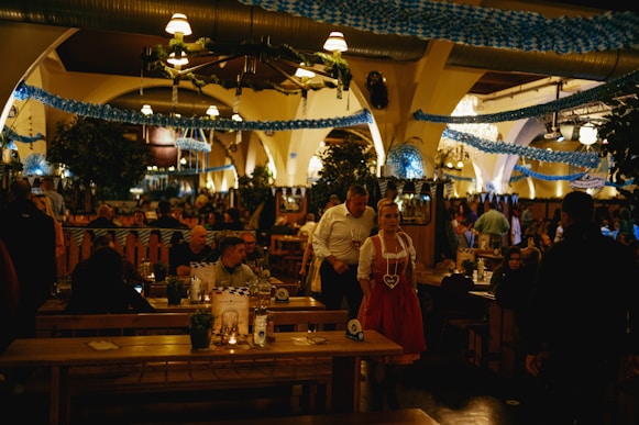A group of people sitting at tables in a restaurant