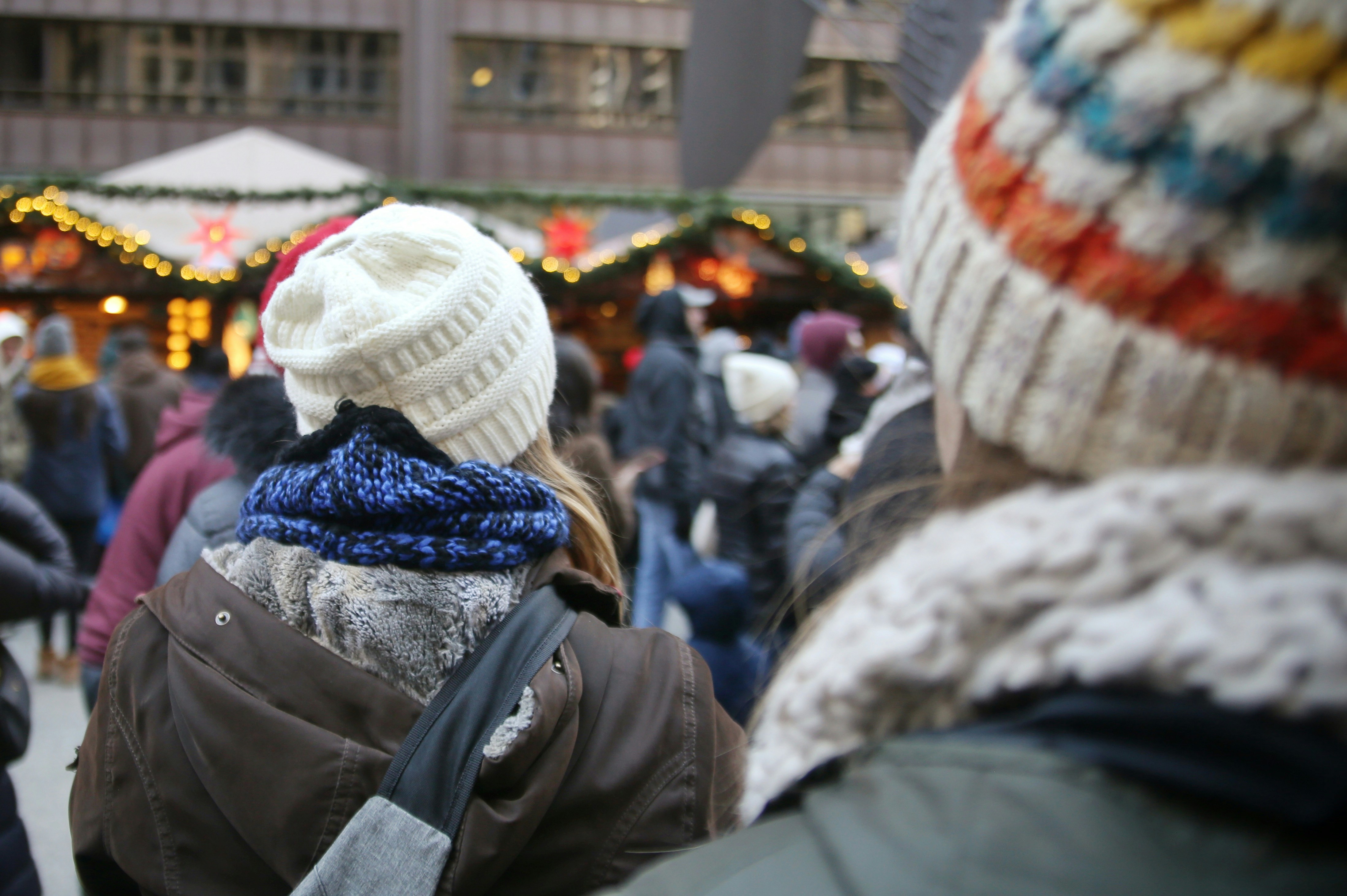 A group of people standing around a market
