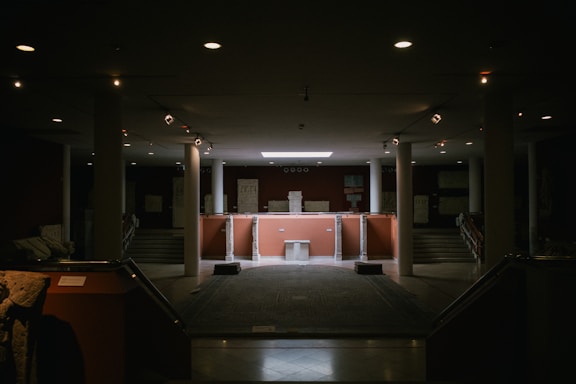 A dimly lit room with stairs leading up to a podium