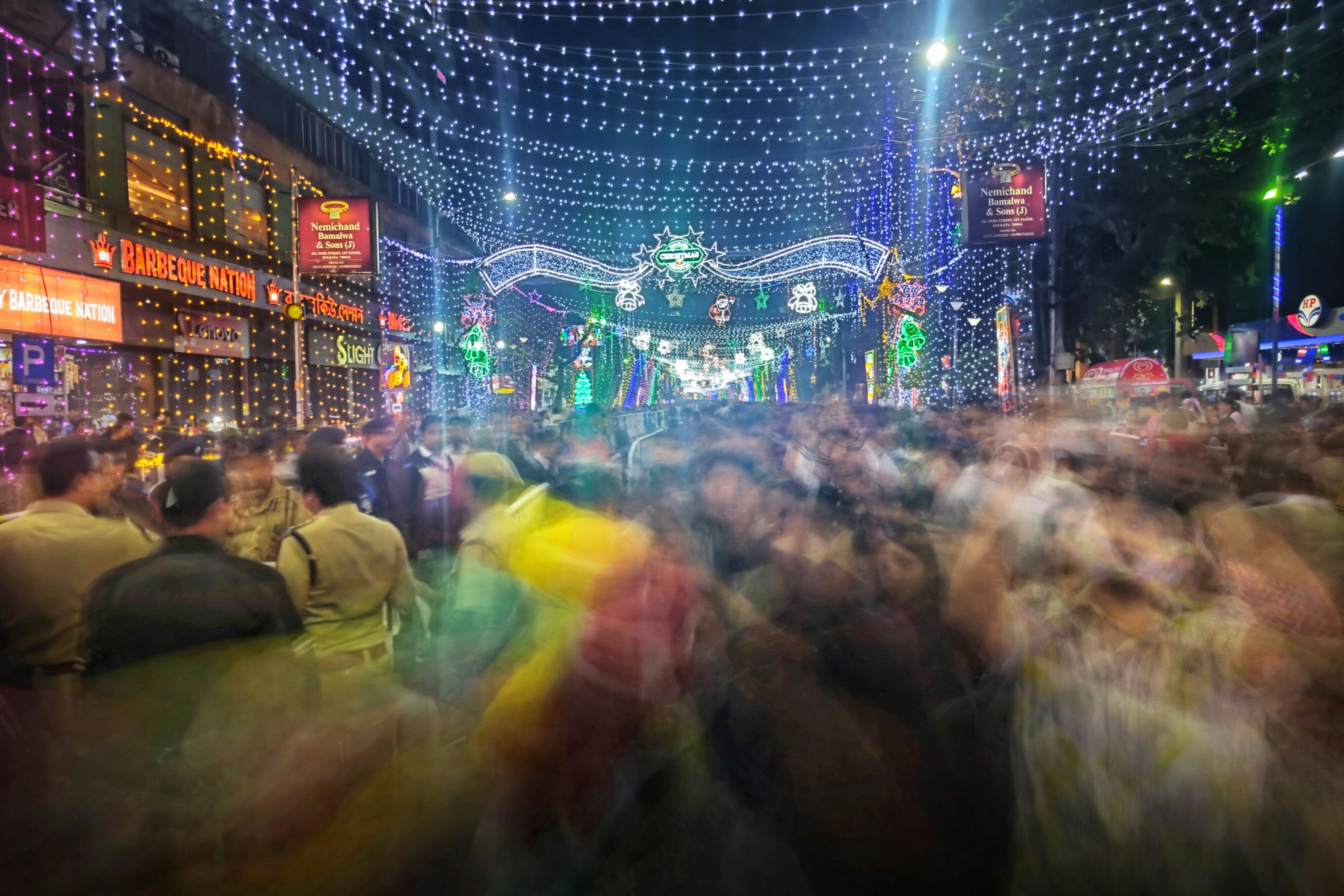 A blurry photo of a crowd of people walking down a street
