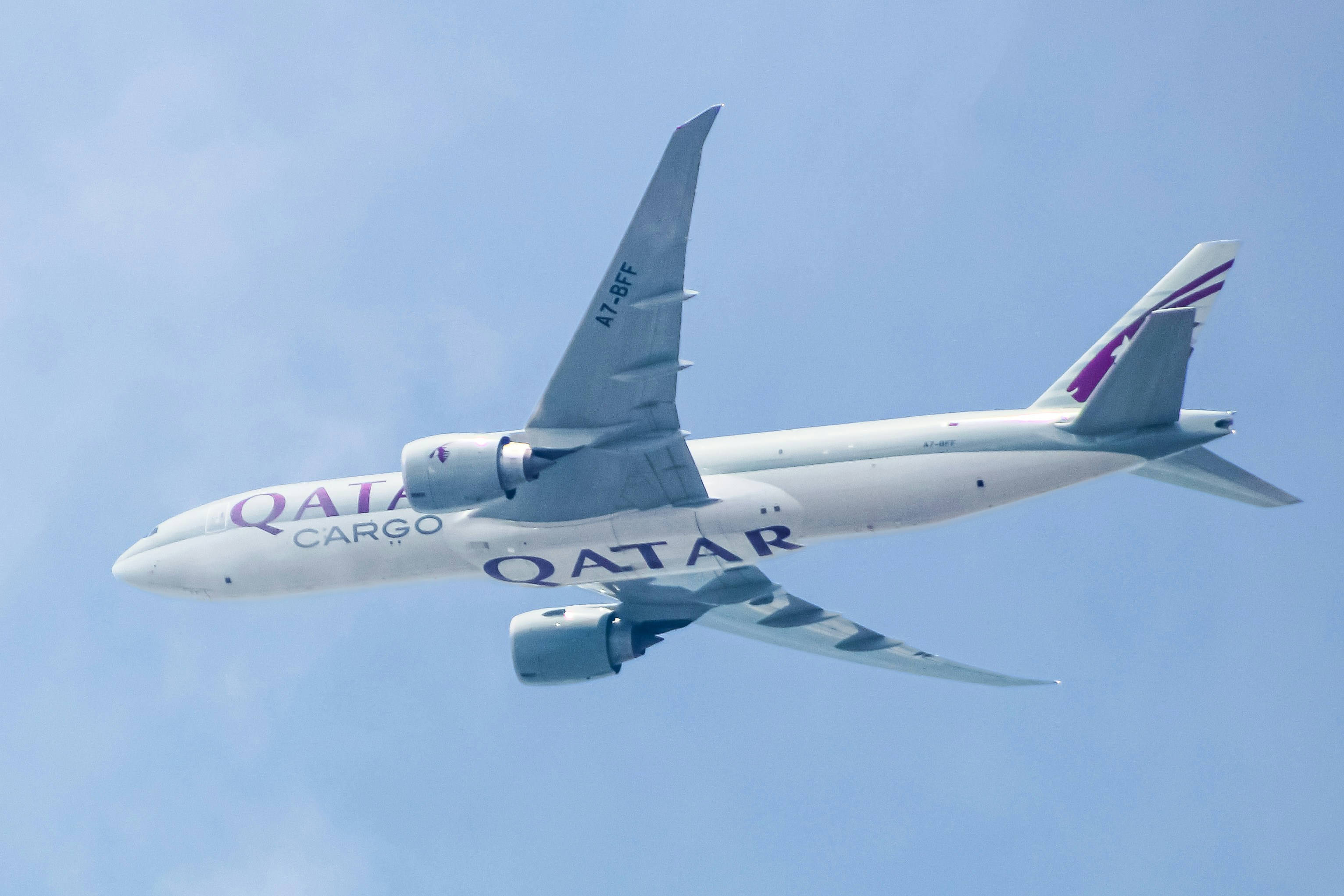 A large passenger jet flying through a blue sky