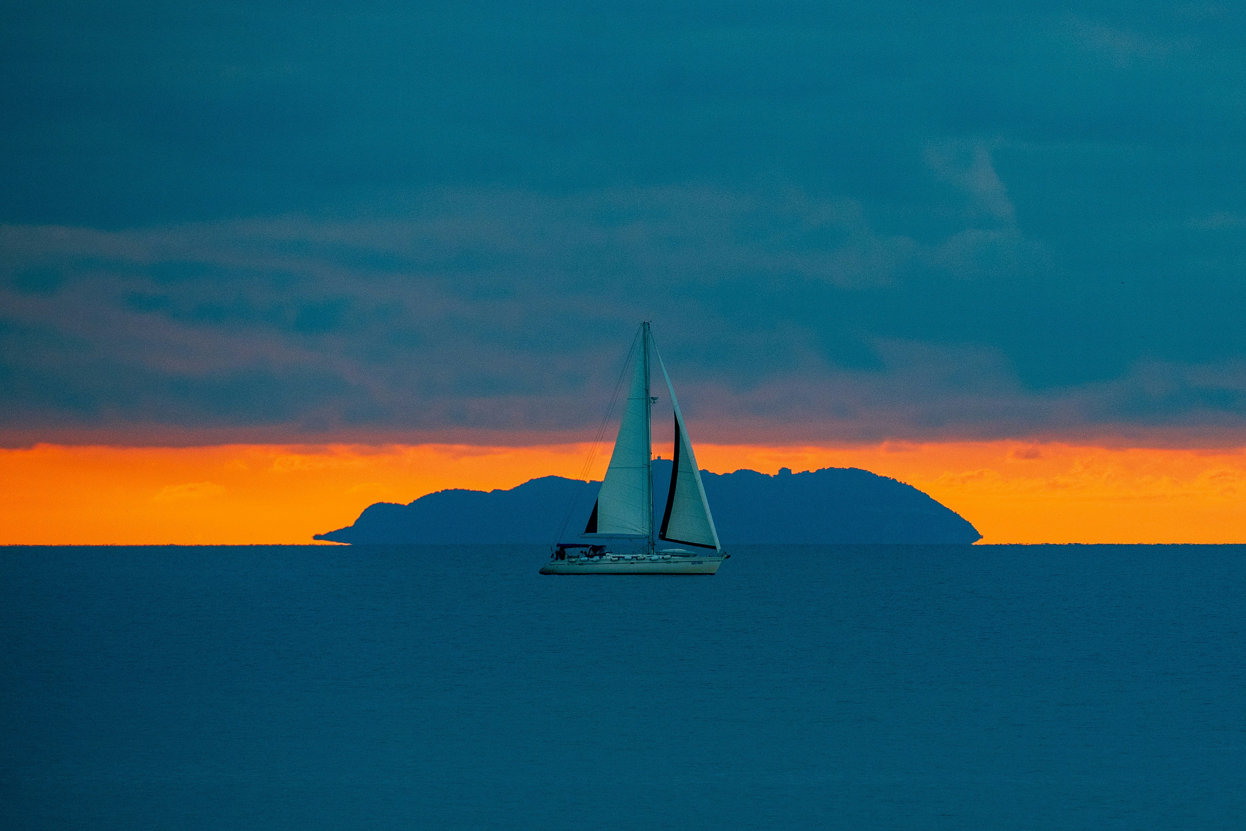 A sailboat in the middle of a large body of water