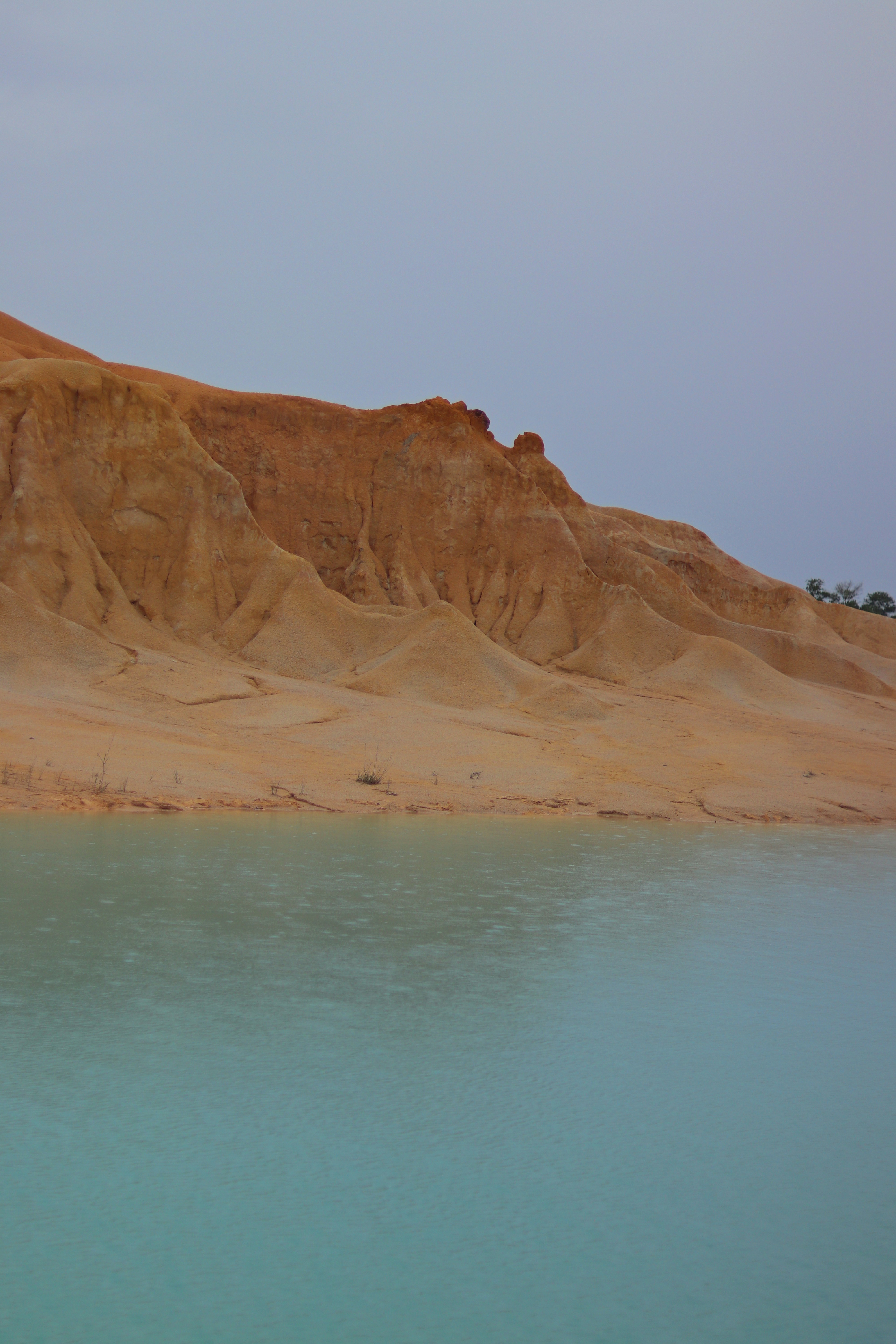 A body of water with a mountain in the background