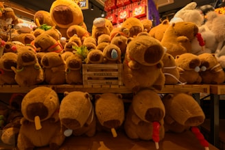 A pile of stuffed animals sitting on top of a wooden table