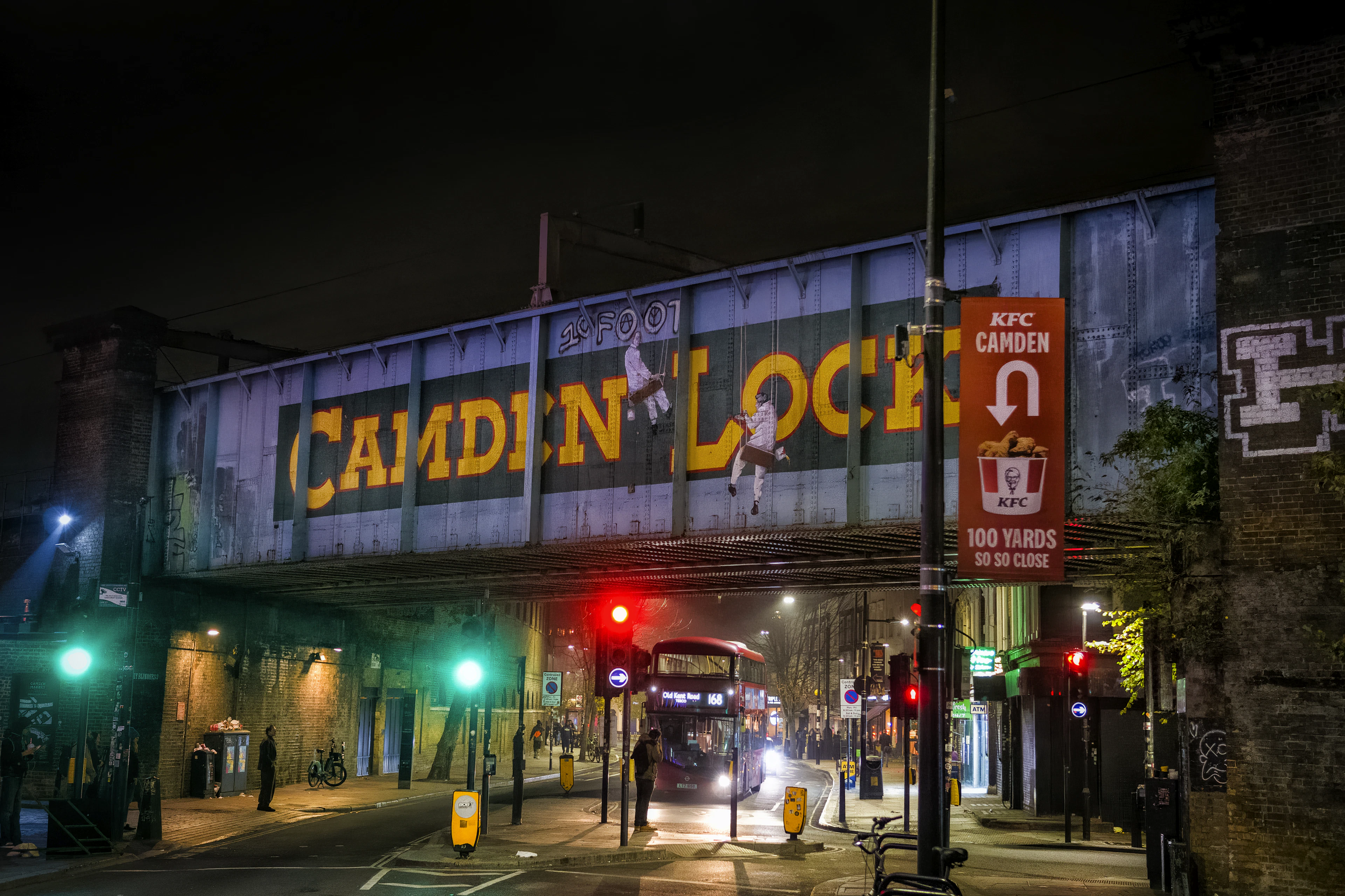 The illuminated Camden Lock railway bridge at night