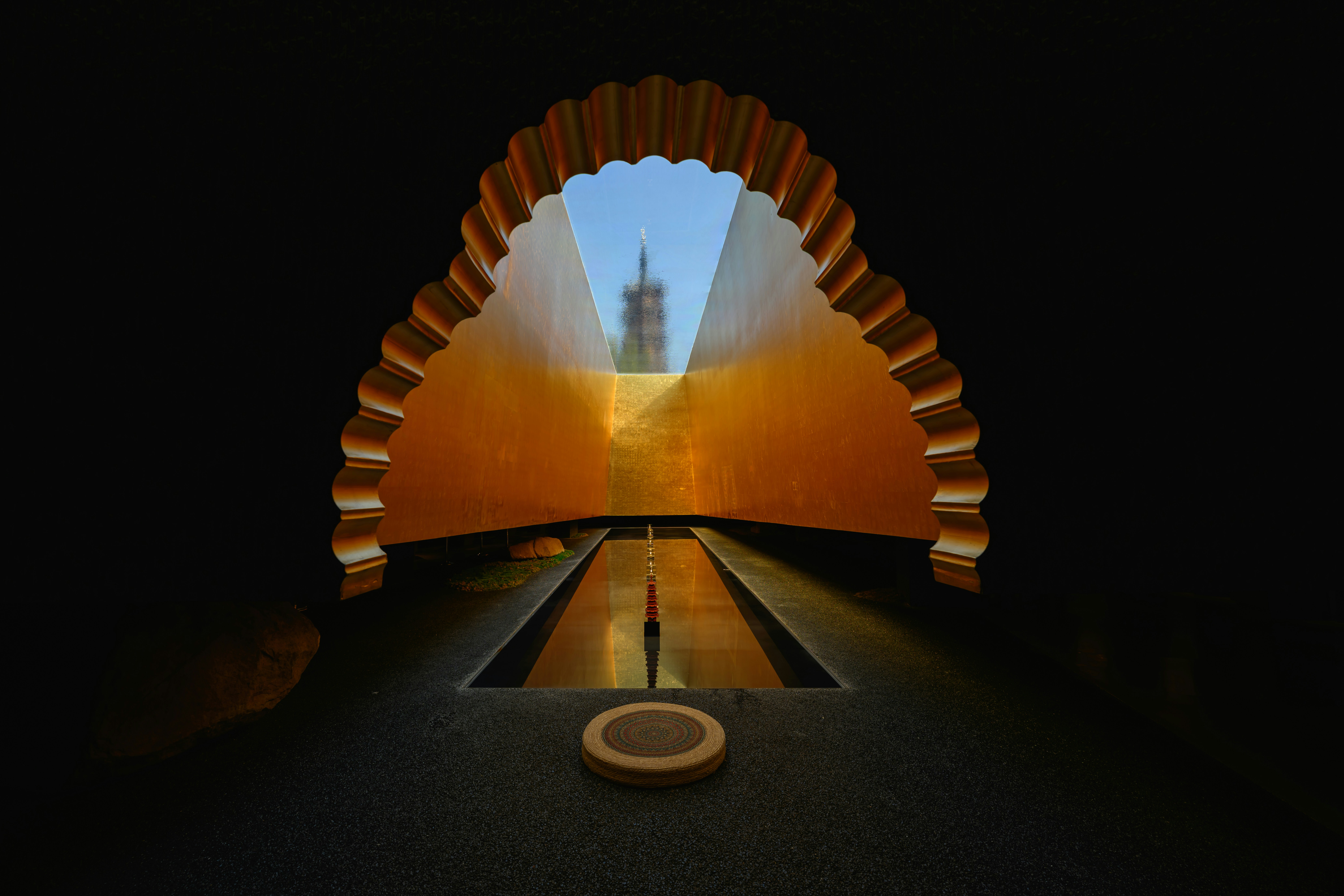A long tunnel with a clock tower in the distance