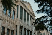 A large building with columns and a clock on the front of it