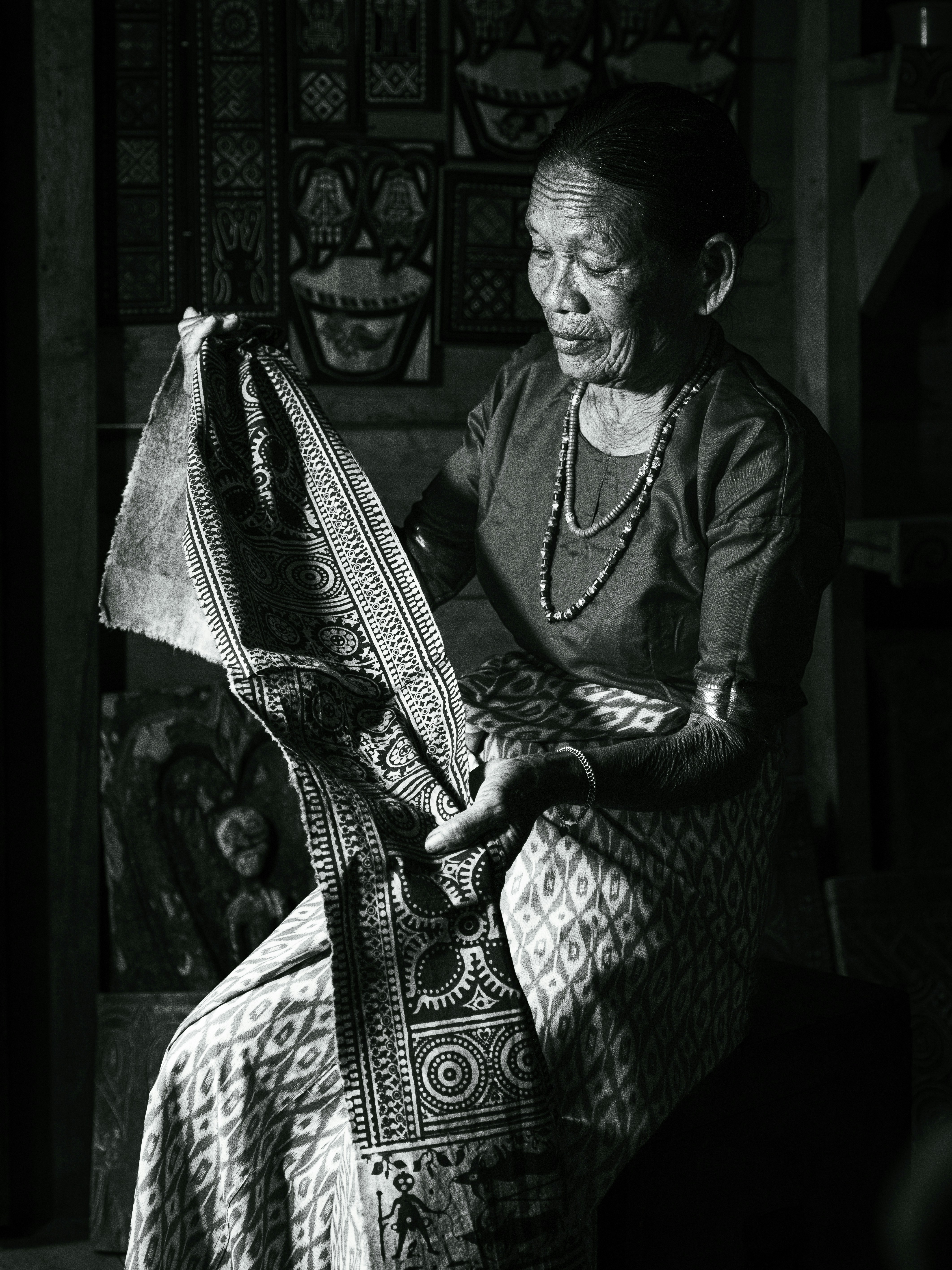 A black and white photo of a woman sitting in a chair