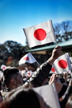 A crowd of people holding up flags in the air