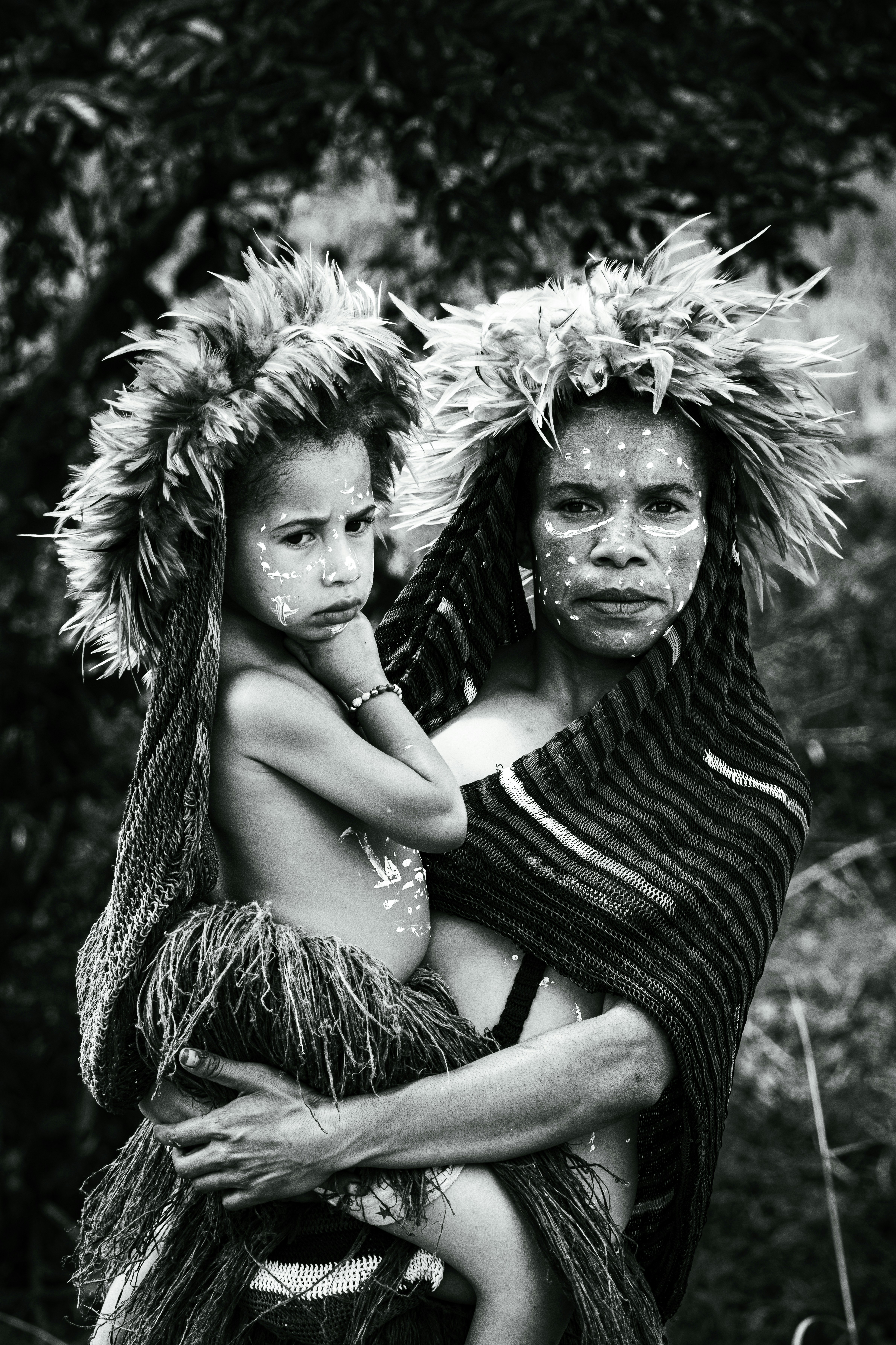 A black and white photo of a woman holding a child