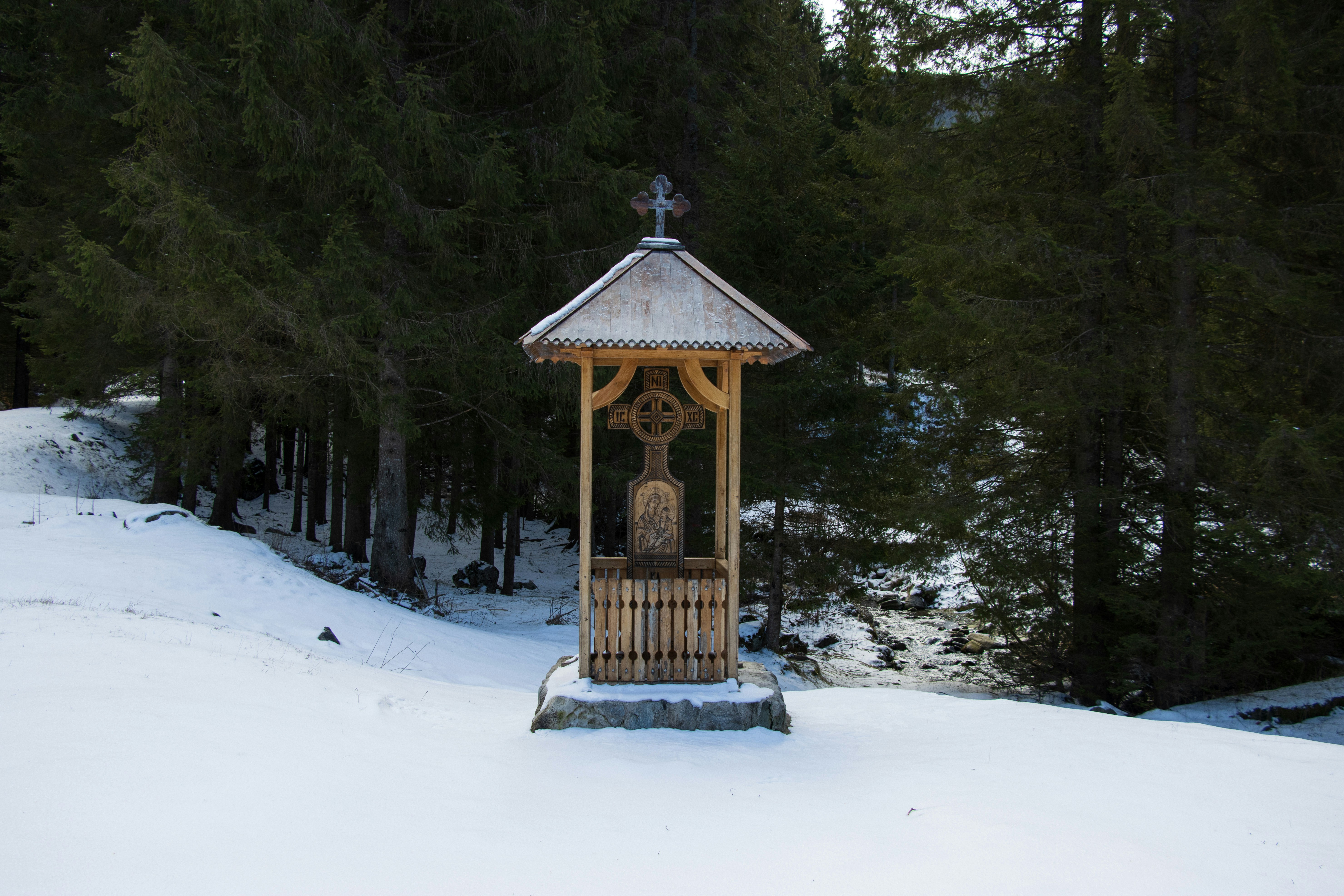 A gazebo in the middle of a snowy field