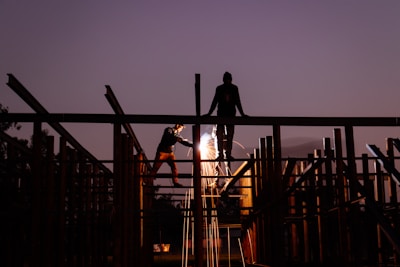A man standing on top of a metal structure