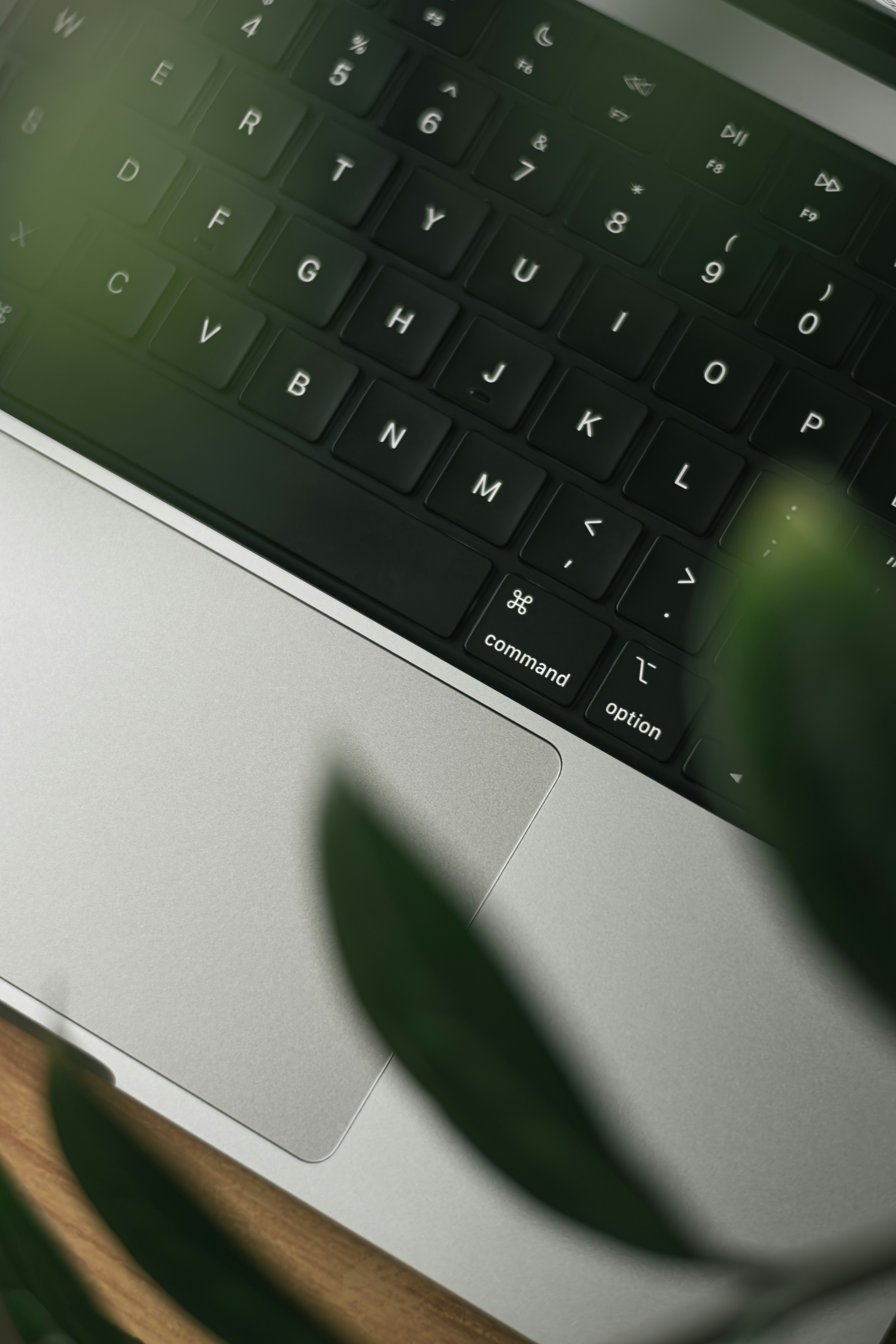 A laptop computer sitting on top of a wooden desk