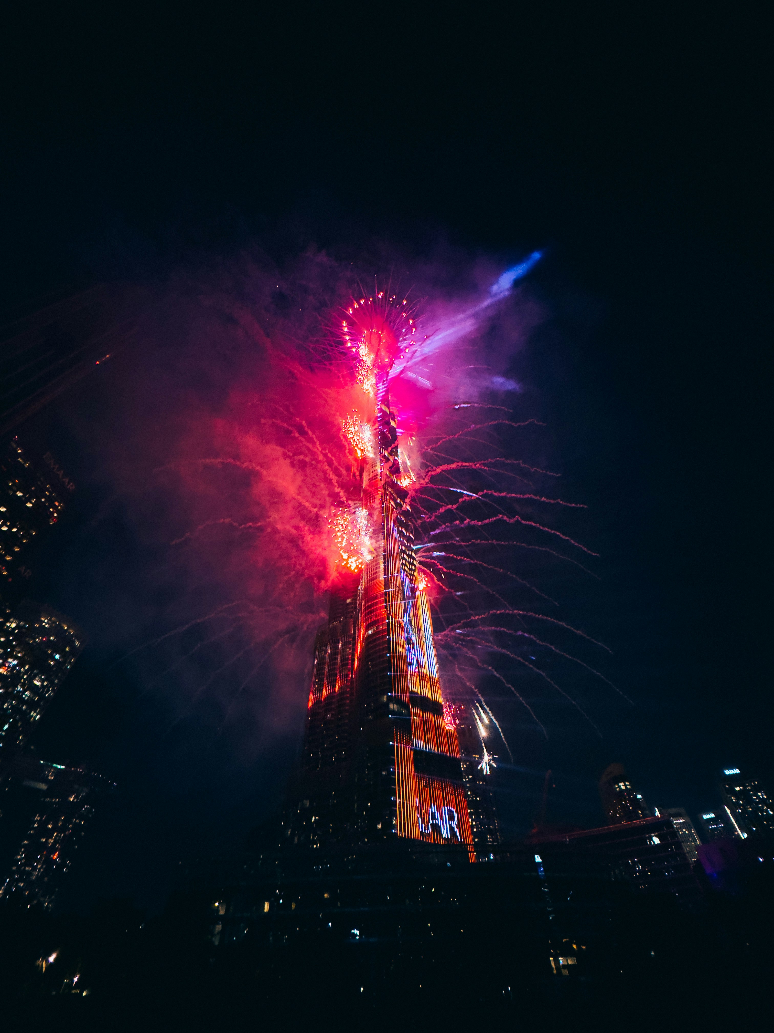 Fireworks are lit up the night sky above a city