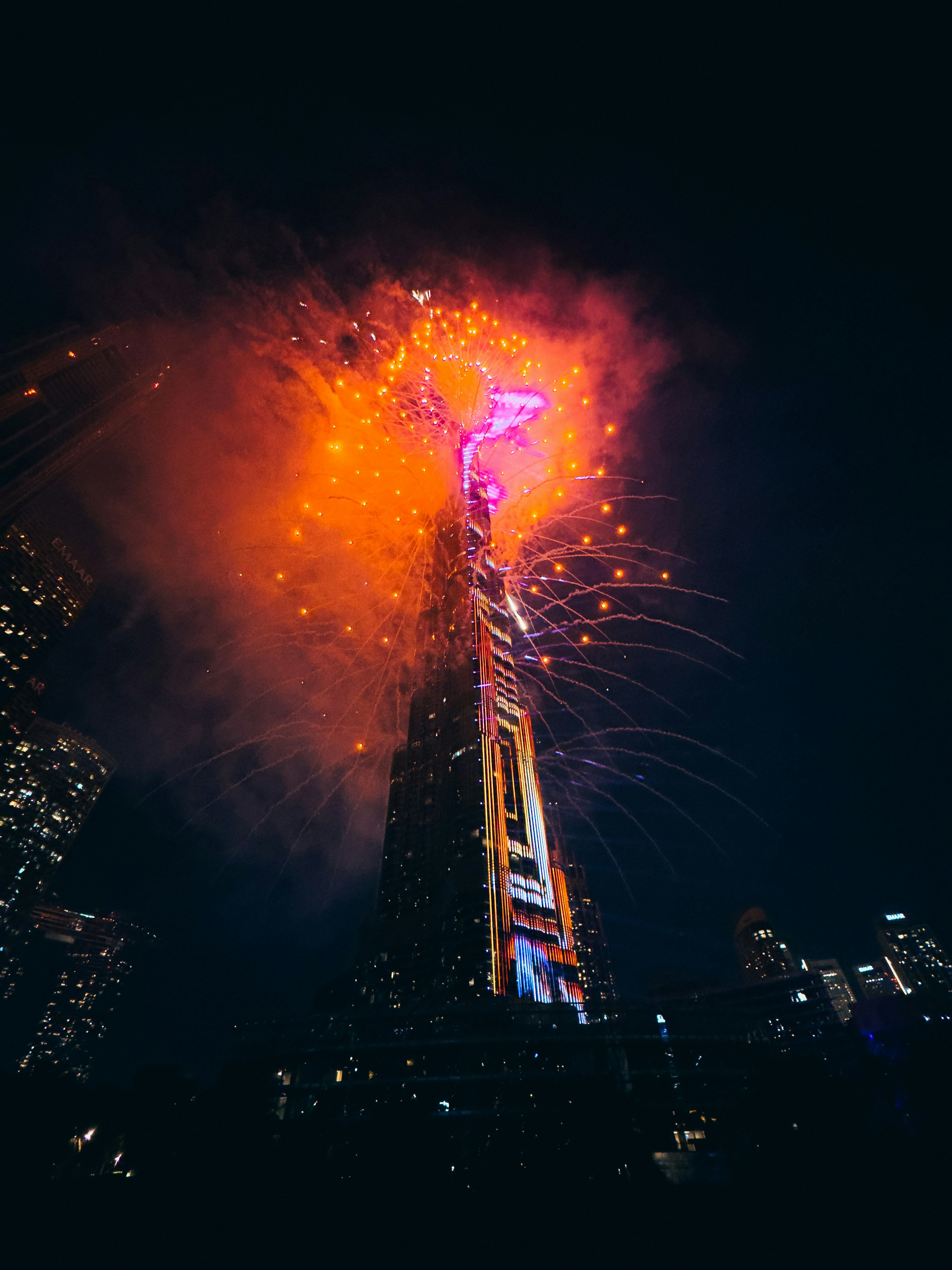 A very tall building with a lot of fireworks in the sky