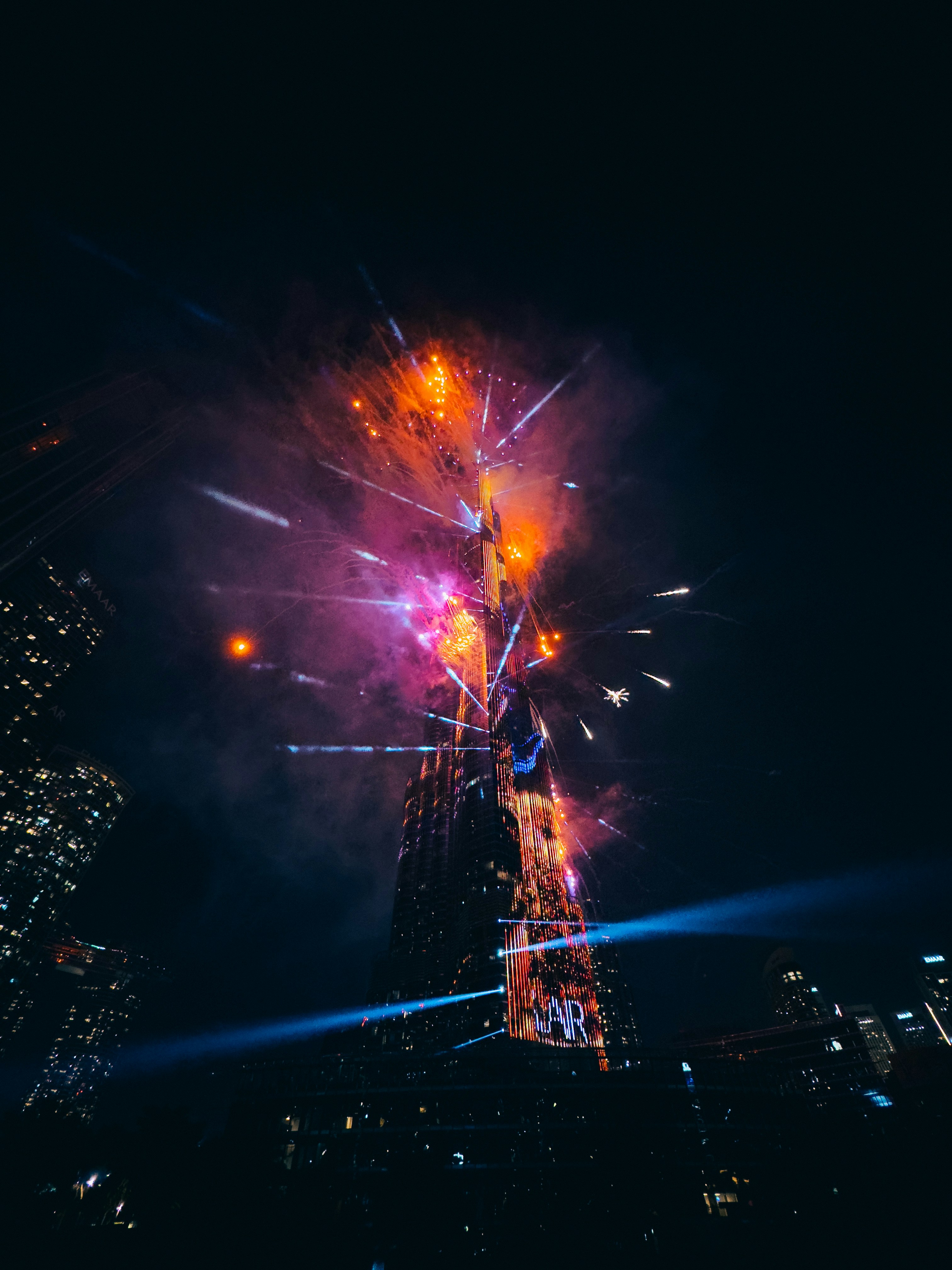 Fireworks are lit up the night sky above a city
