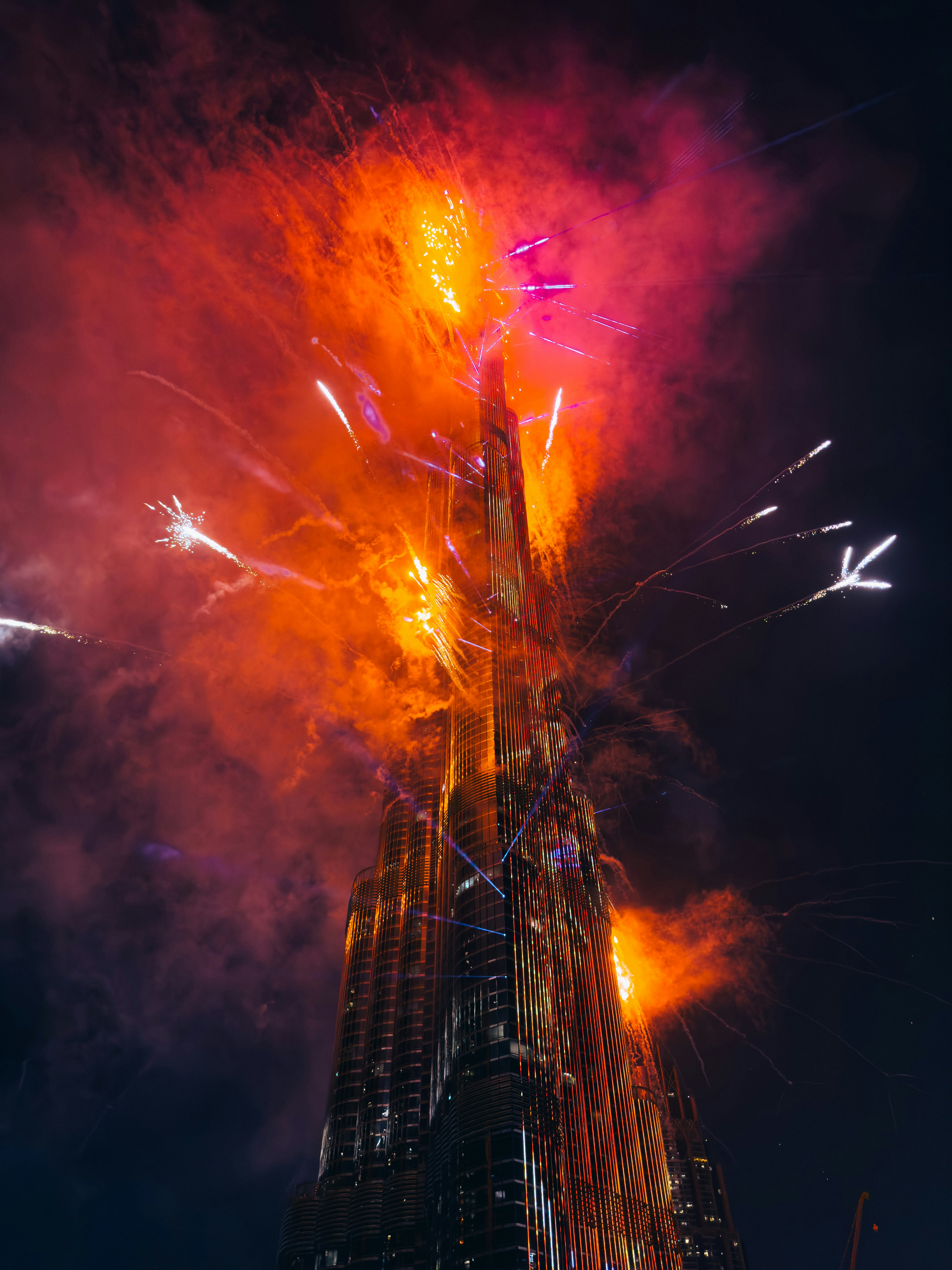 A very tall building with a lot of fireworks in the sky