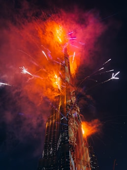 A very tall building with a lot of fireworks in the sky