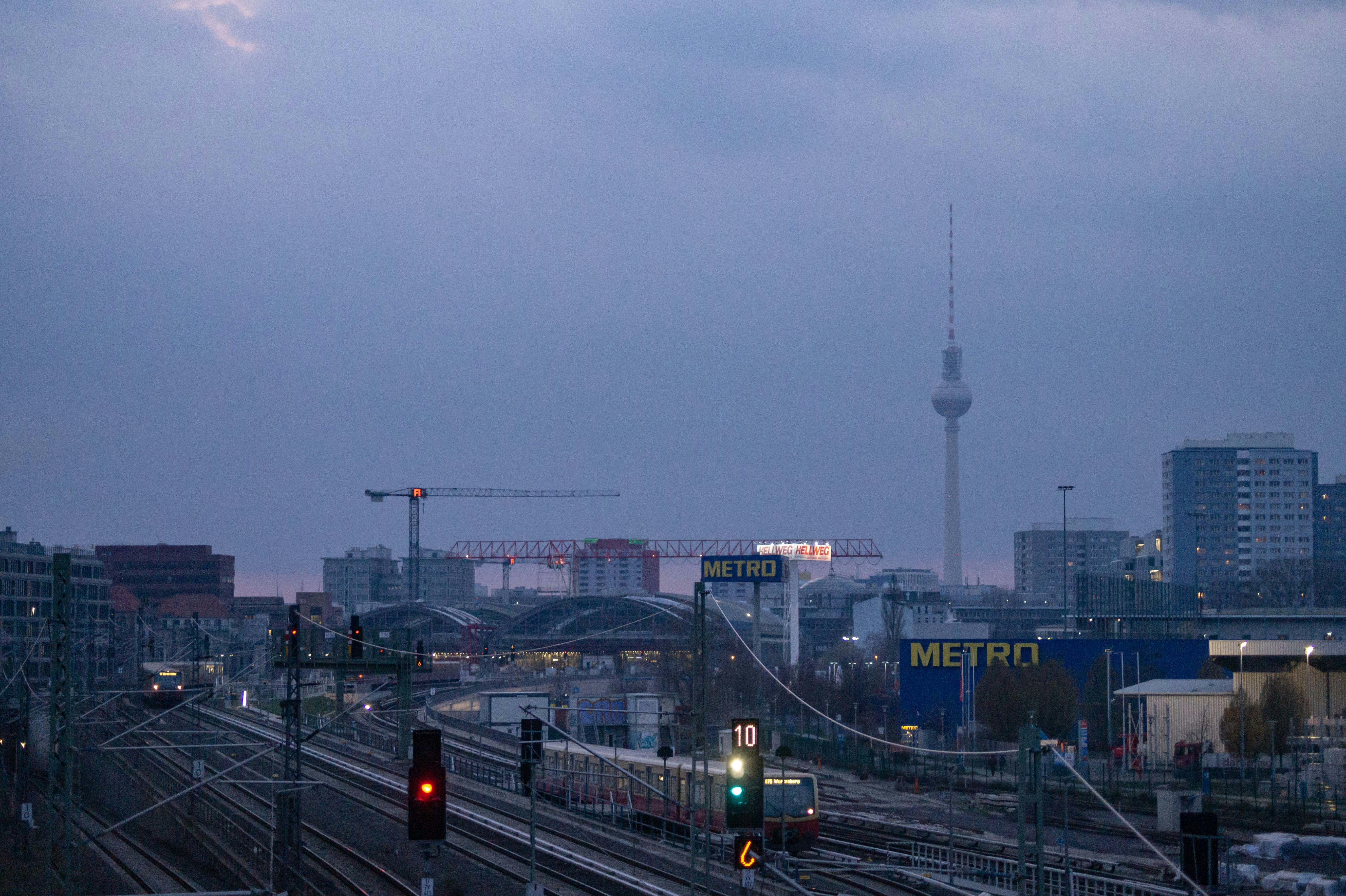 A train traveling down train tracks next to tall buildings