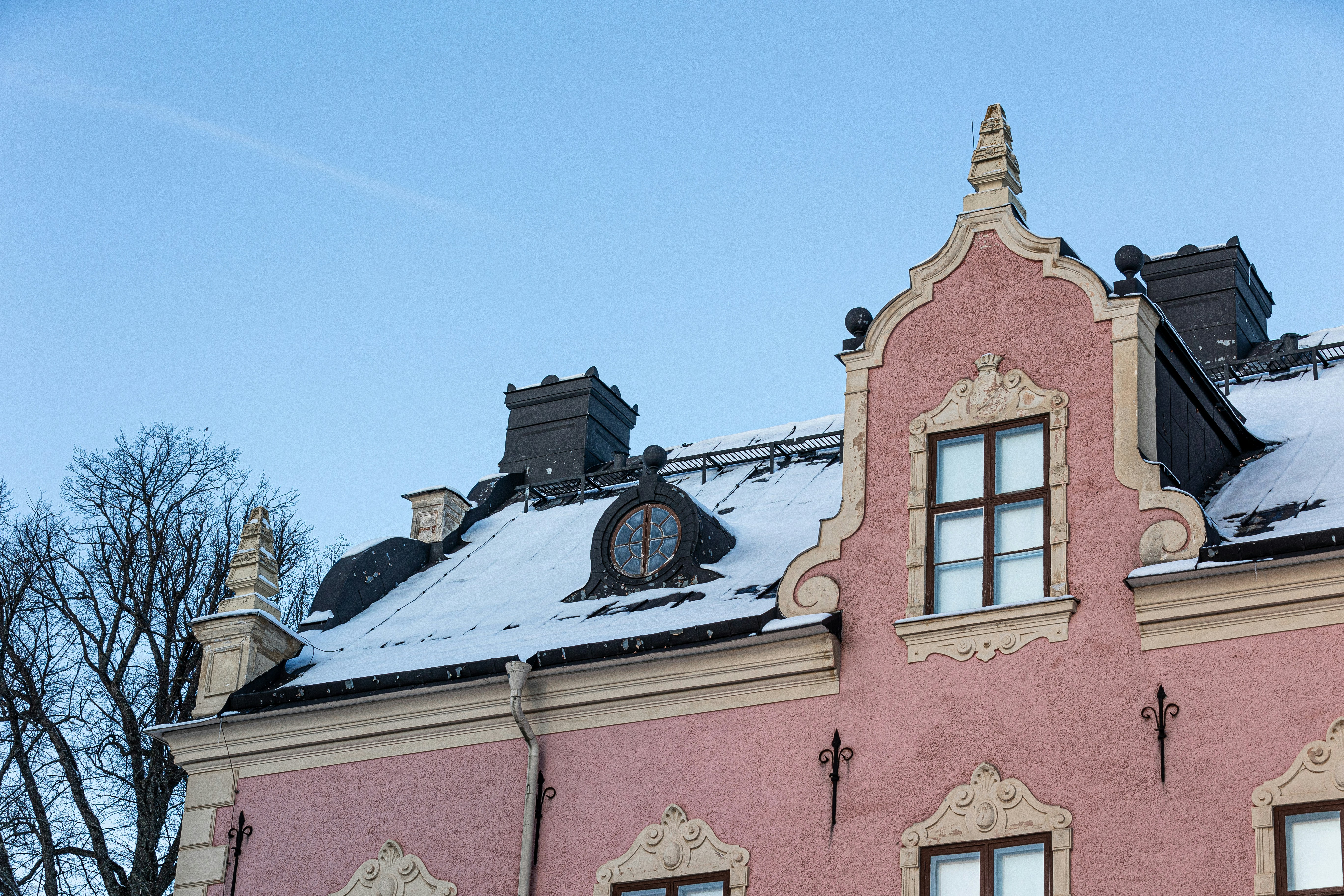 A pink building with a clock on the top of it