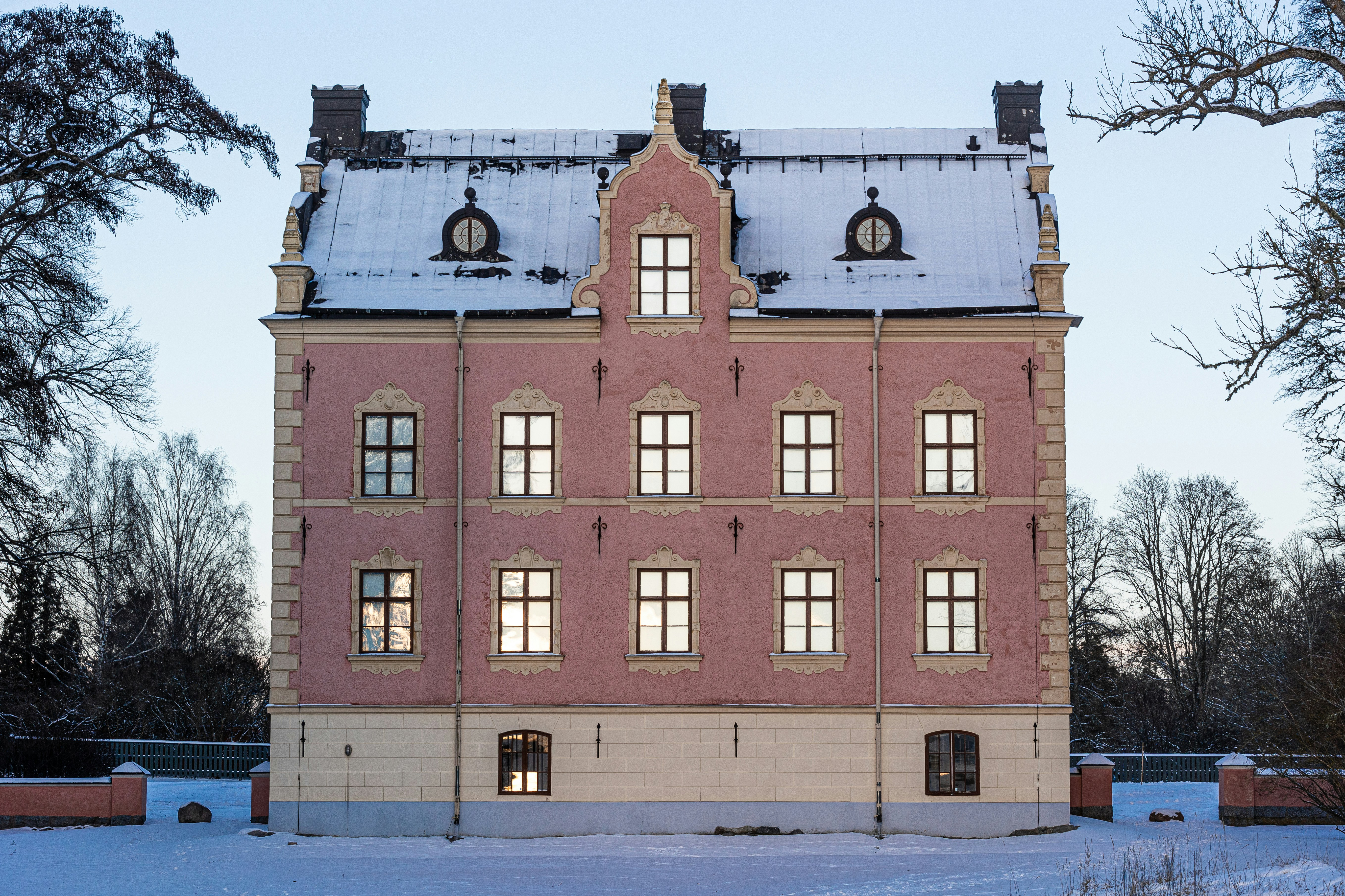 A large brick building with a snow covered roof