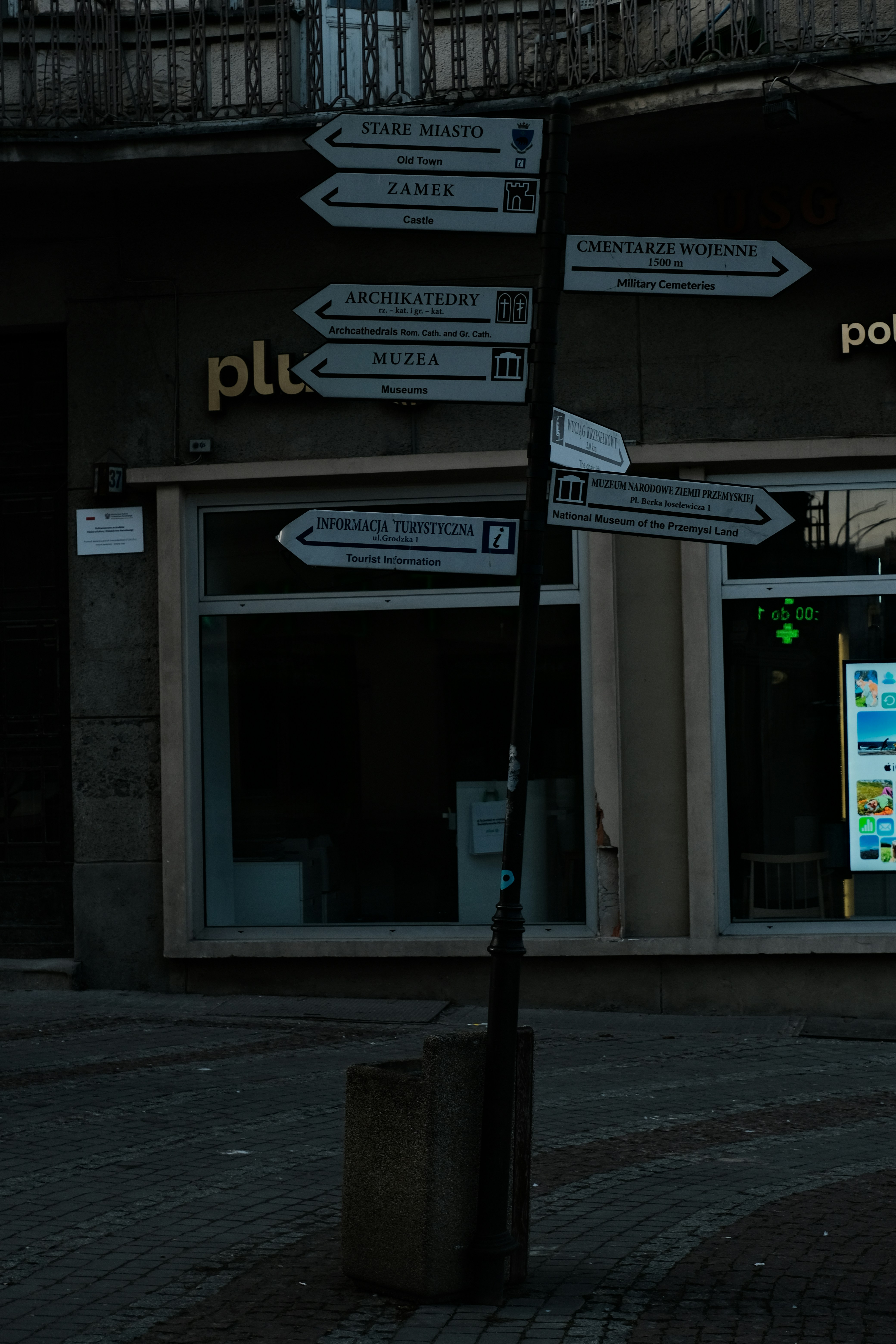 A street sign on a pole in front of a building
