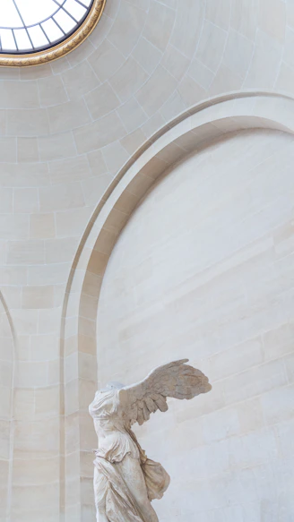 A statue of an angel in a large room