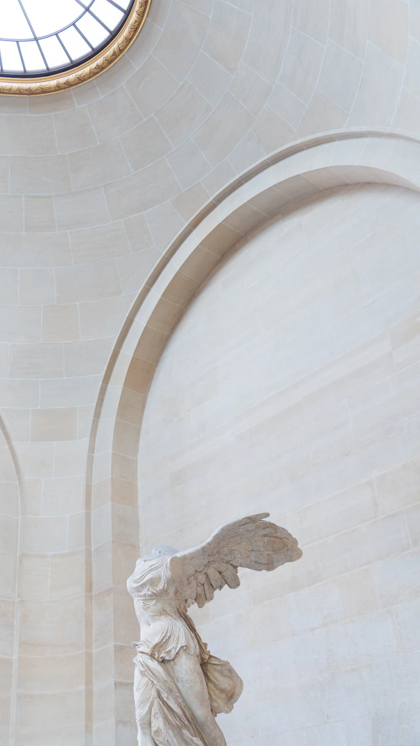 A statue of an angel in a large room