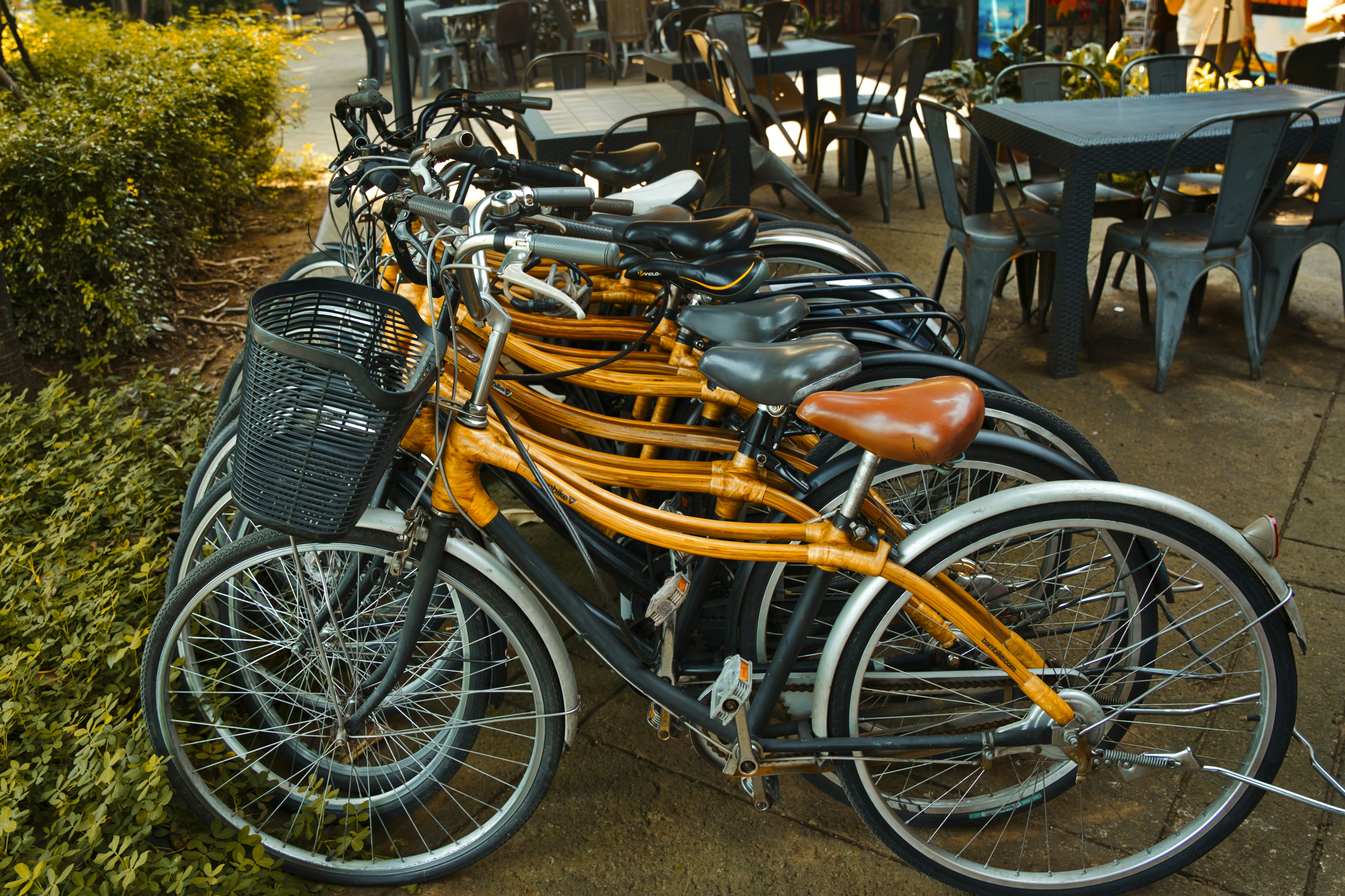 Artisan crafting premium leather bag in workshop with tools and leather materials, warm natural lighting