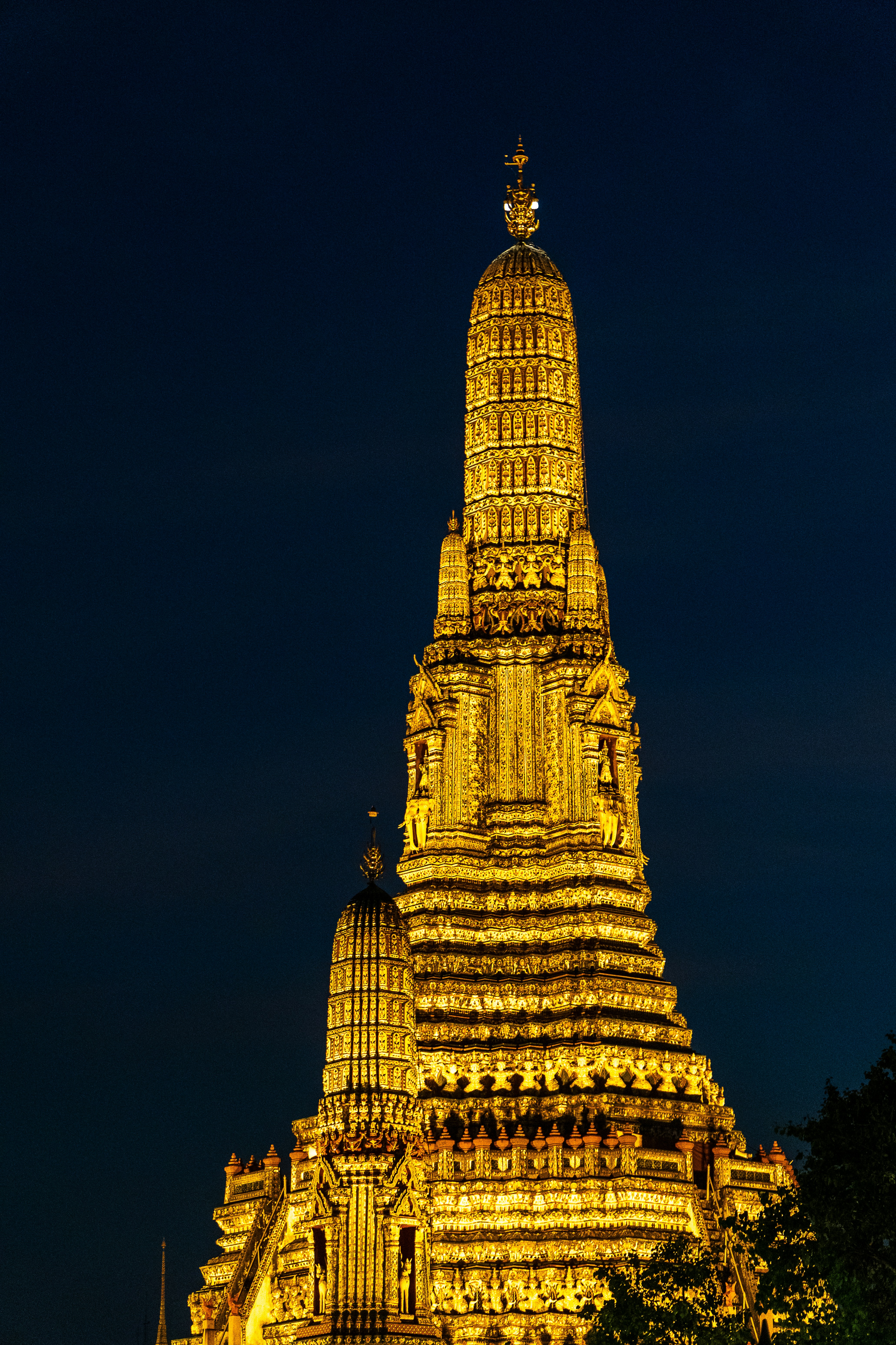 A very tall tower with a clock on it's side